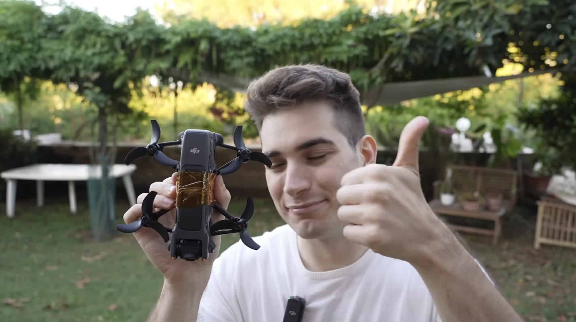 Rimzler giving a thumbs up beside the Avata 2 stripped of its guards.