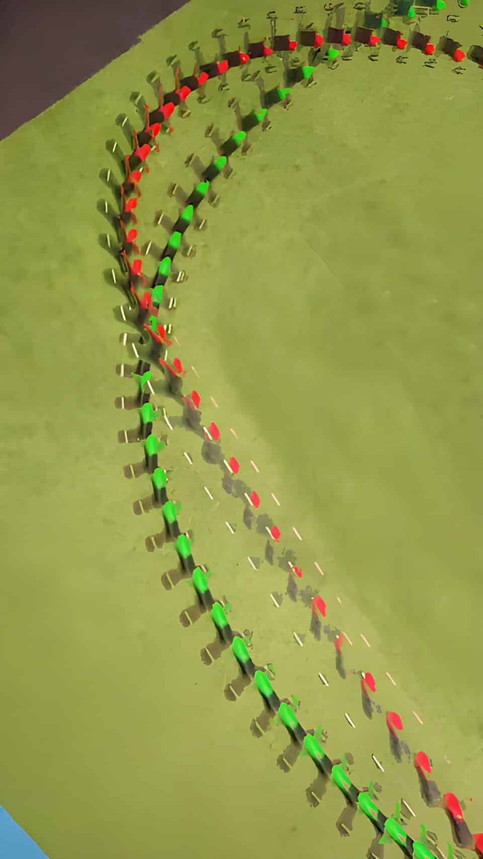 Computed racing trajectory drawn as red and green drone poses over the arena floor.