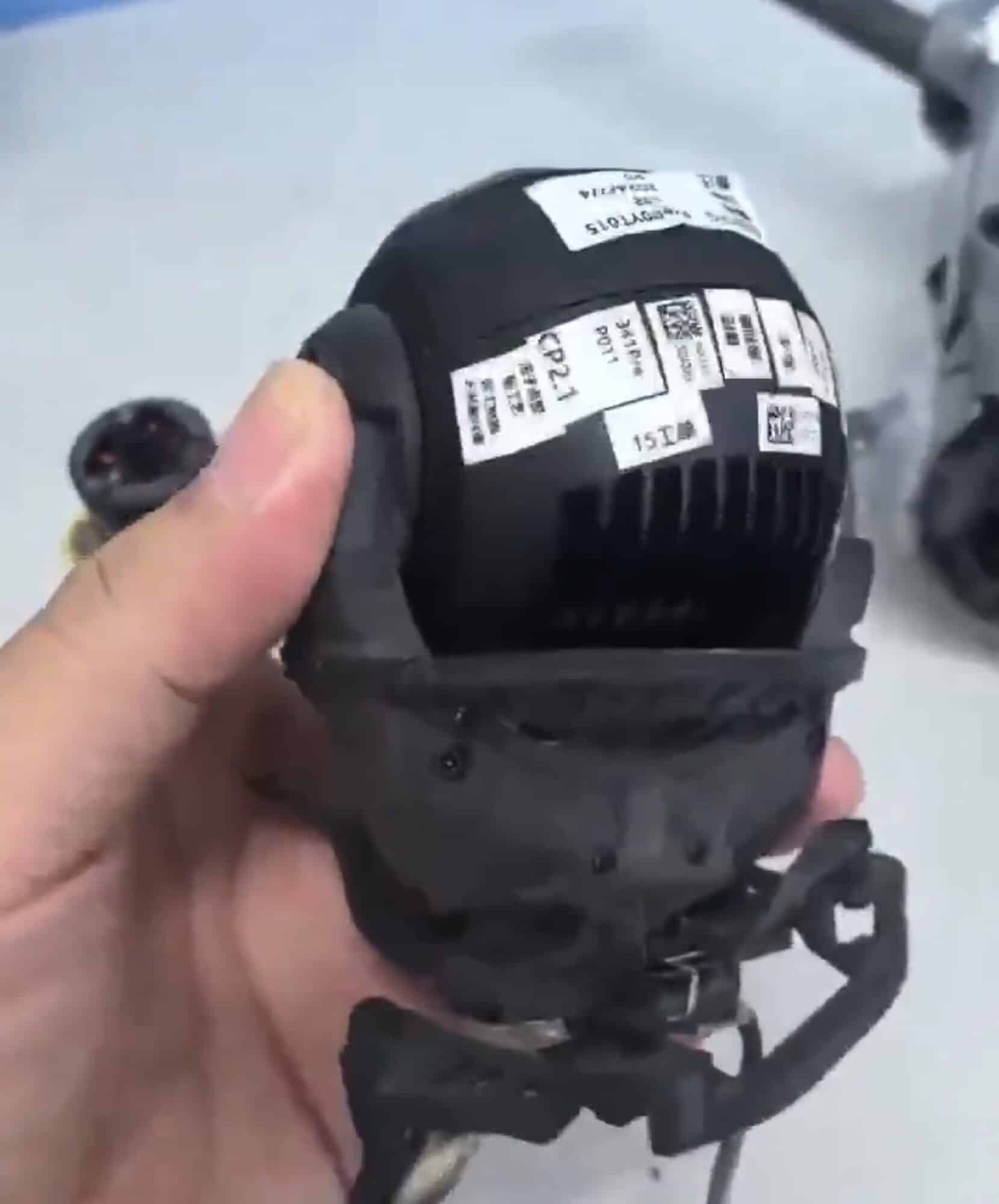 Back of the gimbal ball plastered with QR code and inspection stickers.