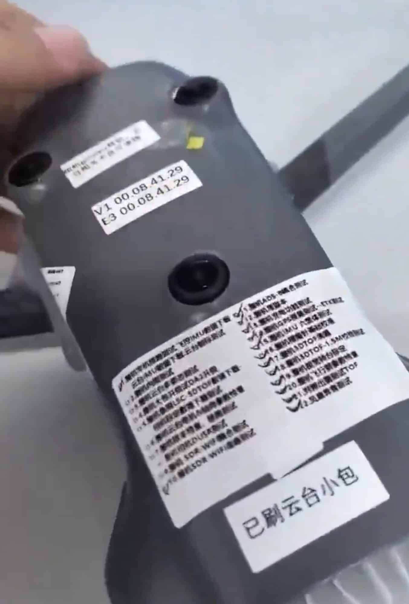 Folded arm and fuselage side carrying version stickers and Chinese factory markings.