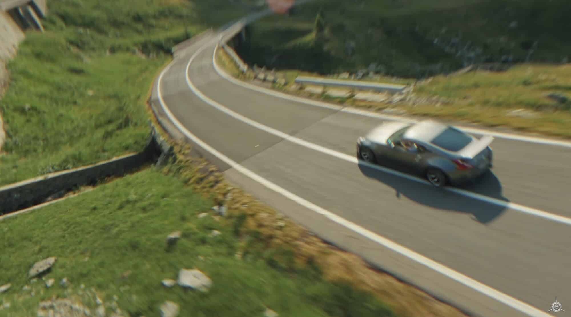 A sports car rounding a sharp bend on the Transfăgărășan, filmed from above.