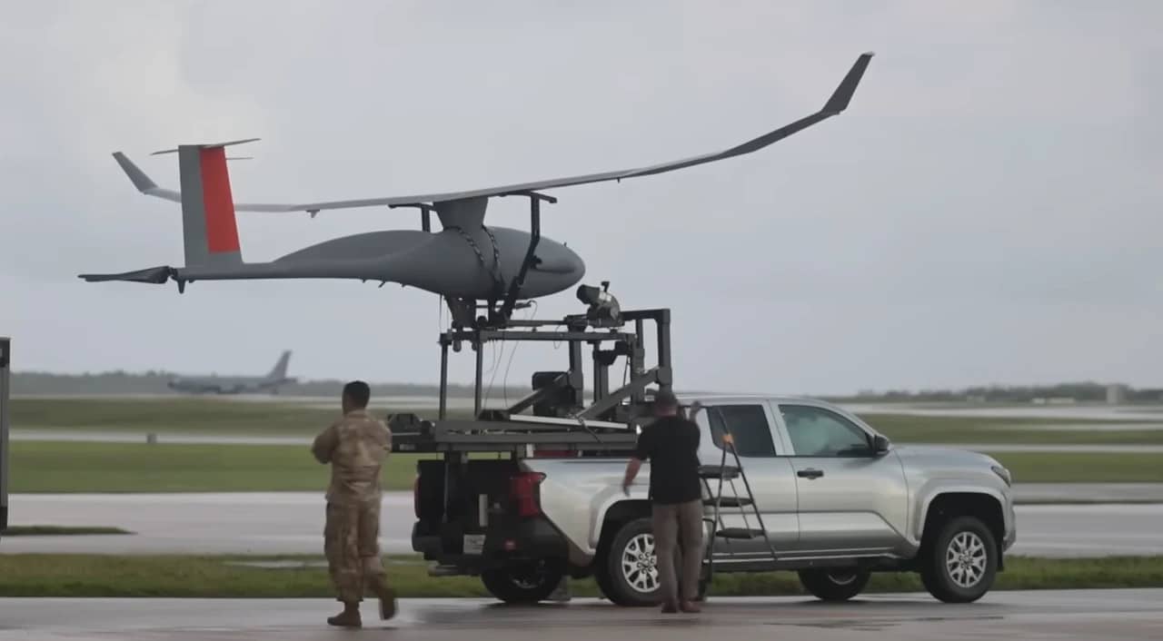 Ground crew preparing the Vanilla UAV on a truck-mounted launch rig at an airfield.