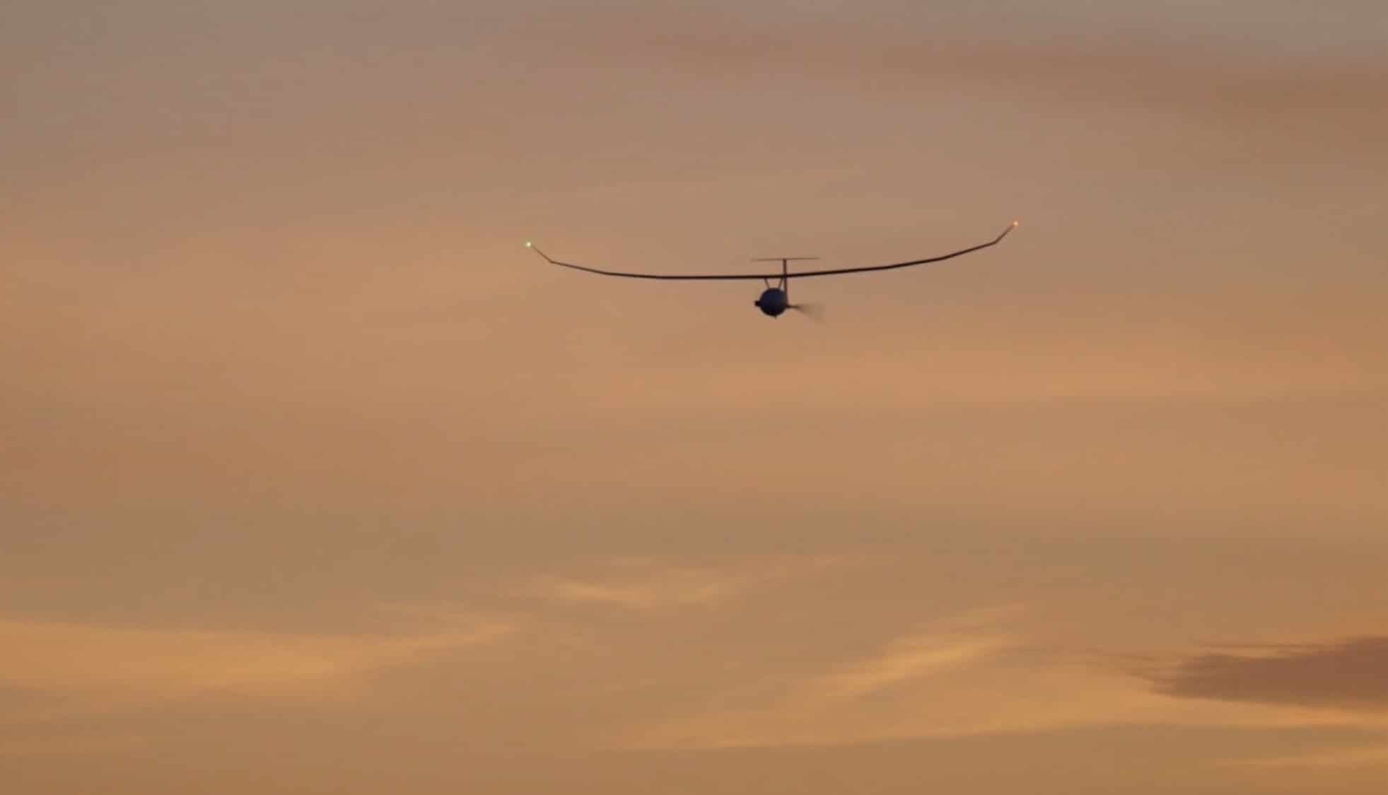 Long-winged Vanilla UAV in flight against an orange sunset sky.