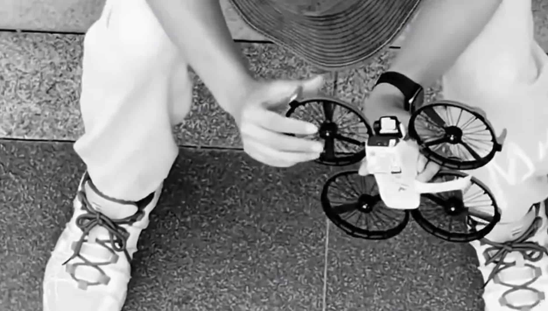 Tester holding the ducted-propeller prototype across his knees, one hand on an arm.