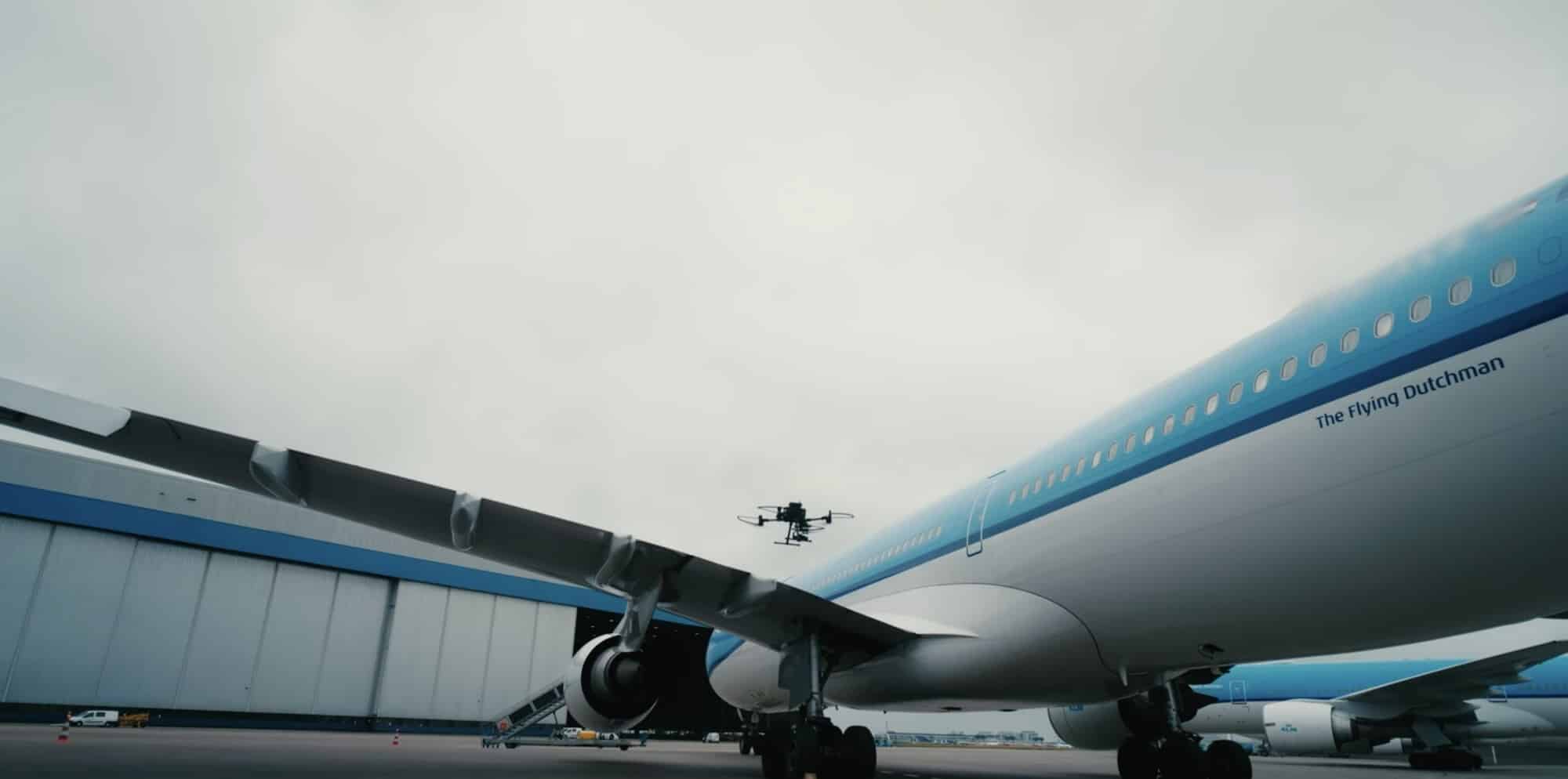 AI-enabled DJI Matrice drone performing an inspection of a KLM aircraft at Schiphol Airport.