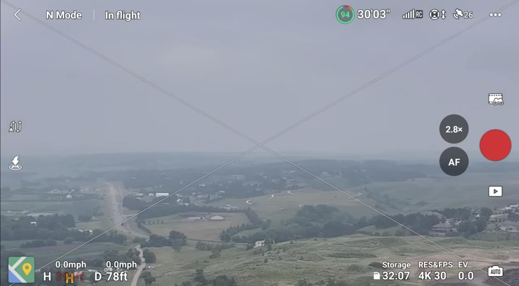 Smoke-hazed aerial view of farmland in the DJI Fly app, crossed out onscreen.
