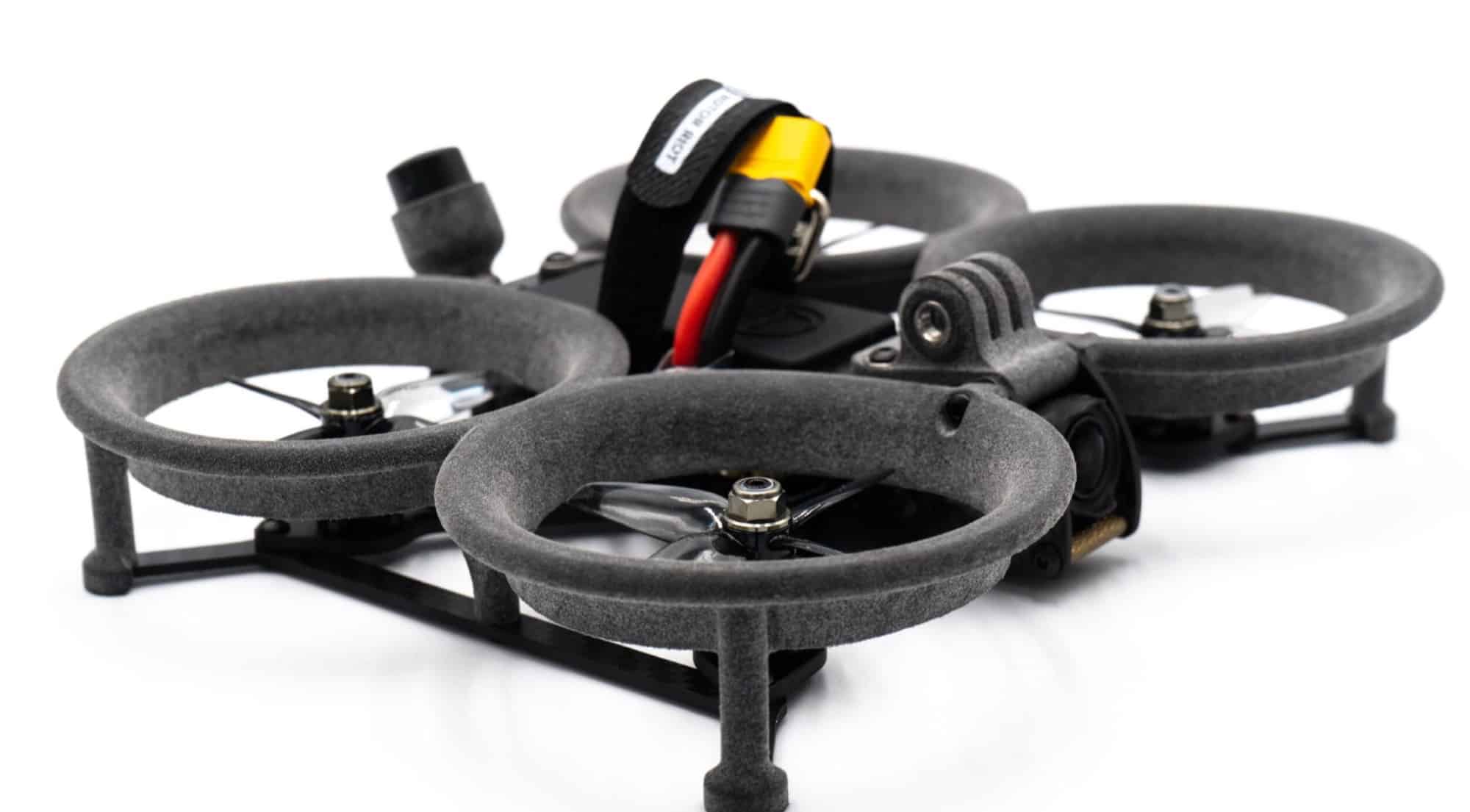 Low angle on the SkyLite cinewhoop showing its gray 3D-printed propeller ducts.