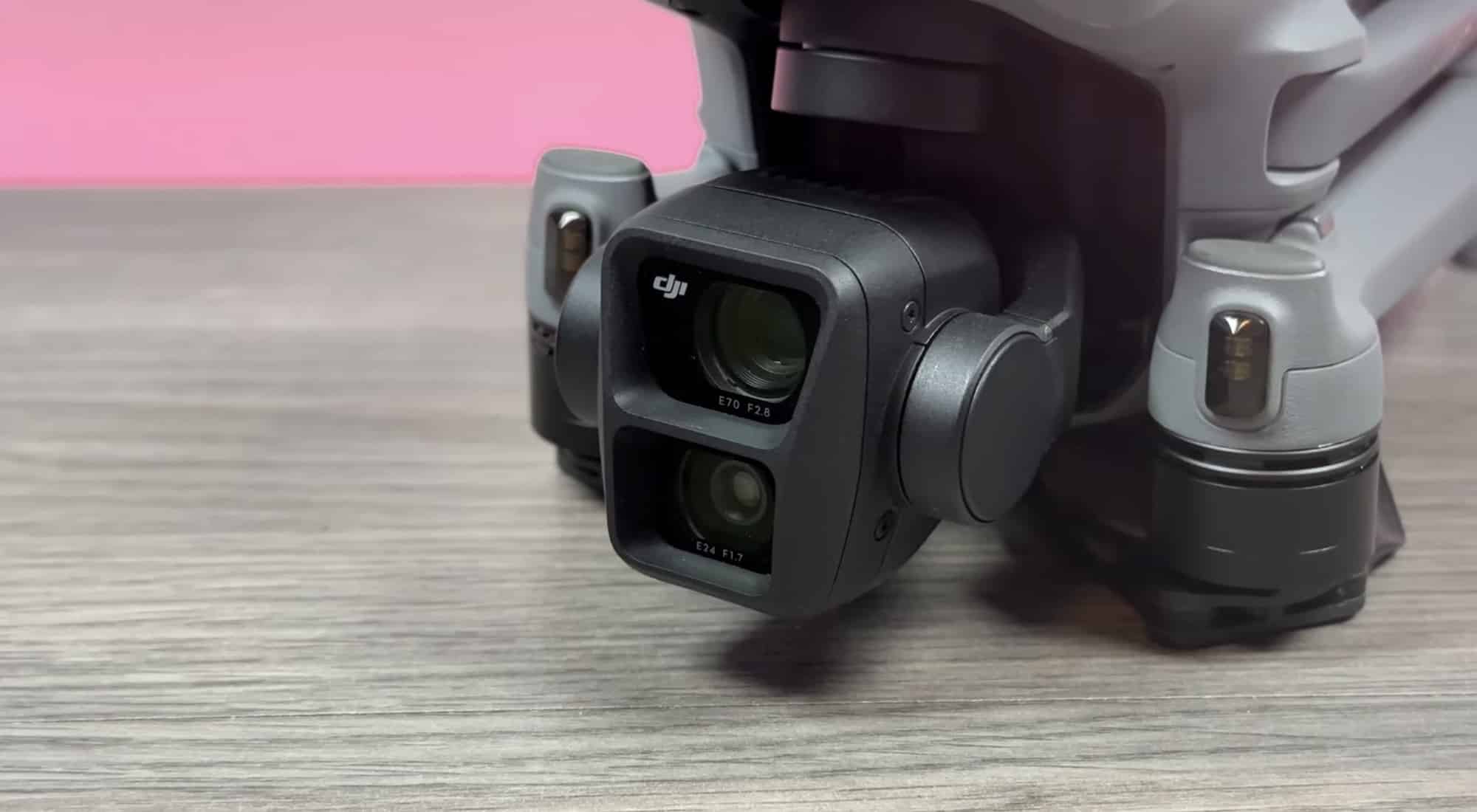 Close-up of the Air 3 dual-lens gimbal camera resting on pale wood.
