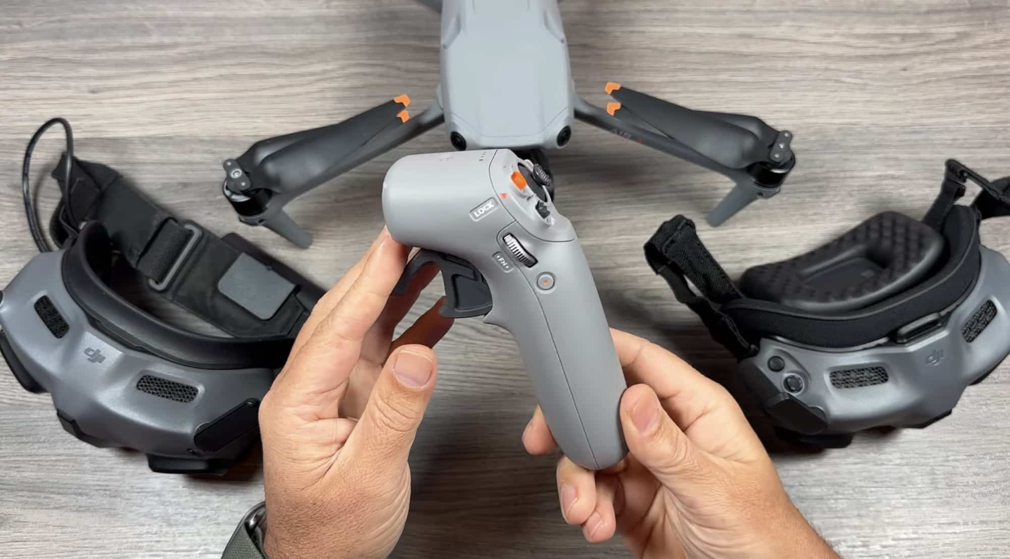 Close view of the RC Motion 3 controller held above a folded Air 3.