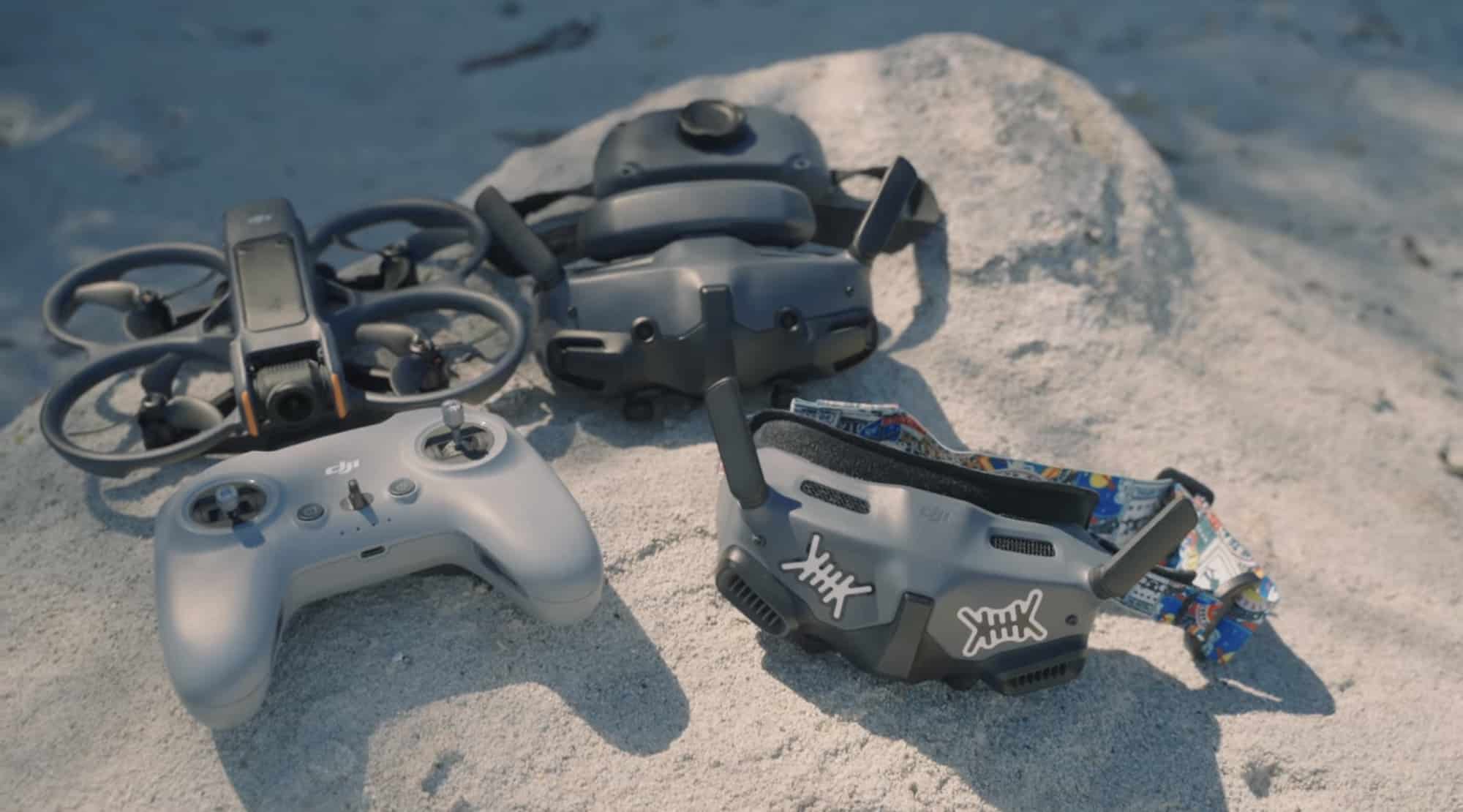 Avata 2, Goggles 3 and remote controller laid out on a sunlit rock.