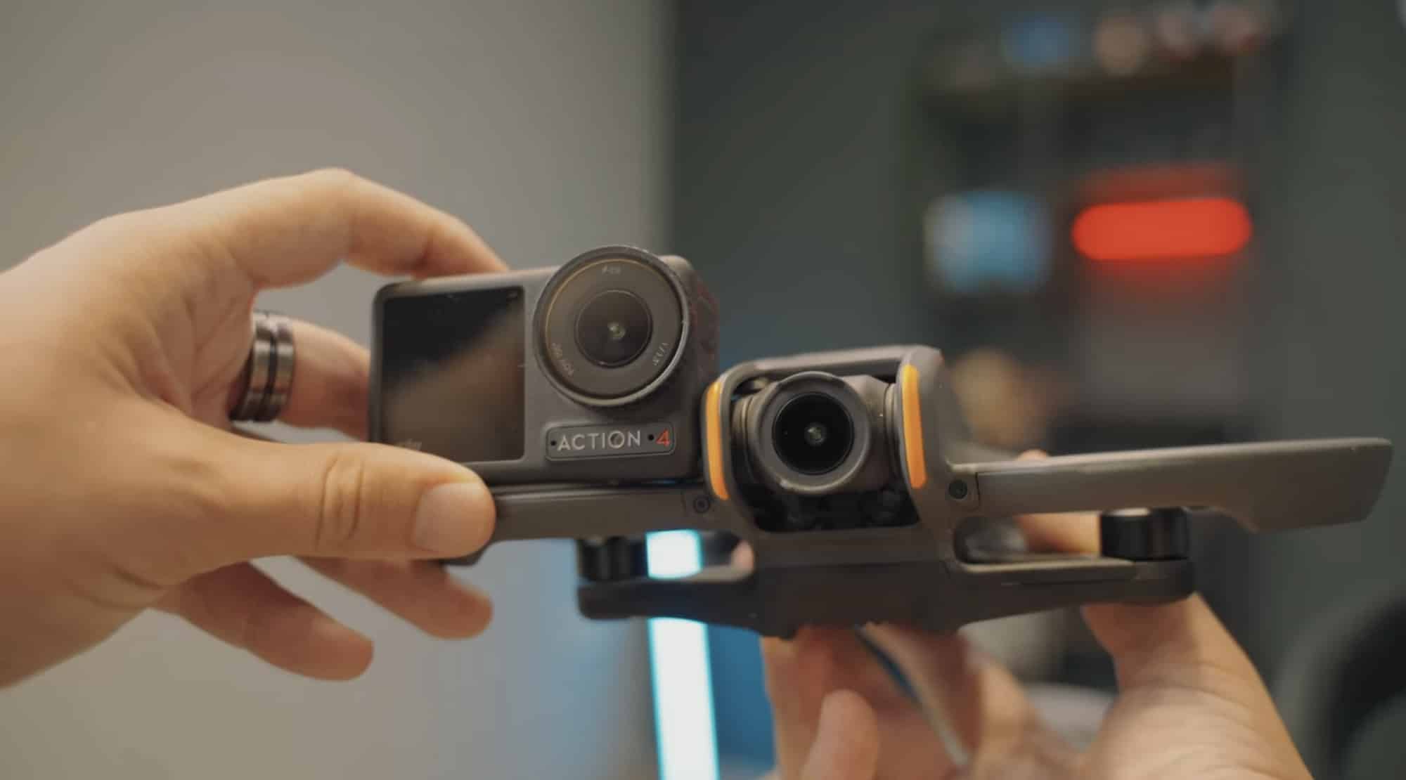 Hand holding an Osmo Action 4 beside the Avata 2 for a camera comparison.