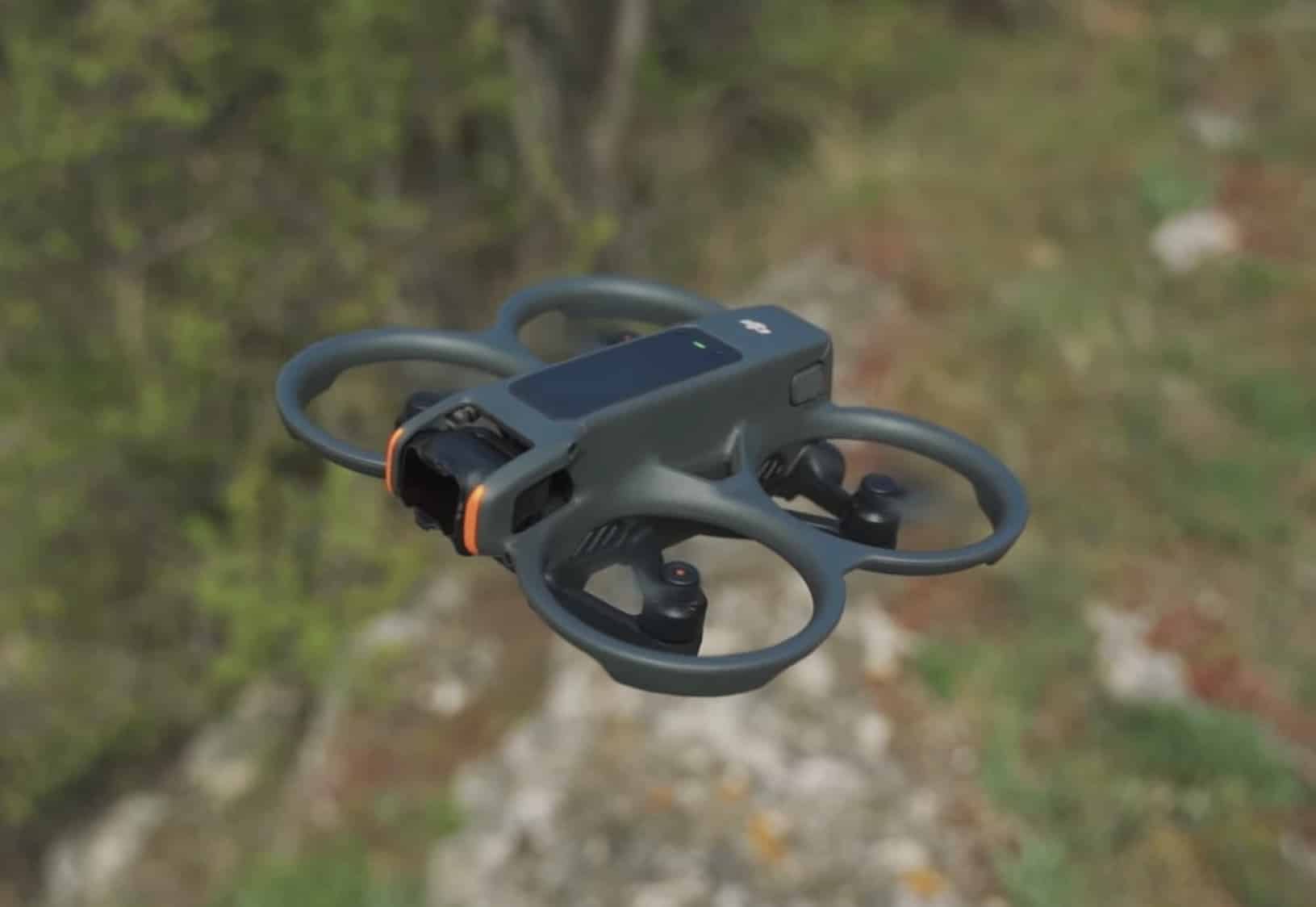 Avata 2 hovering low over a rocky grass-covered hillside.