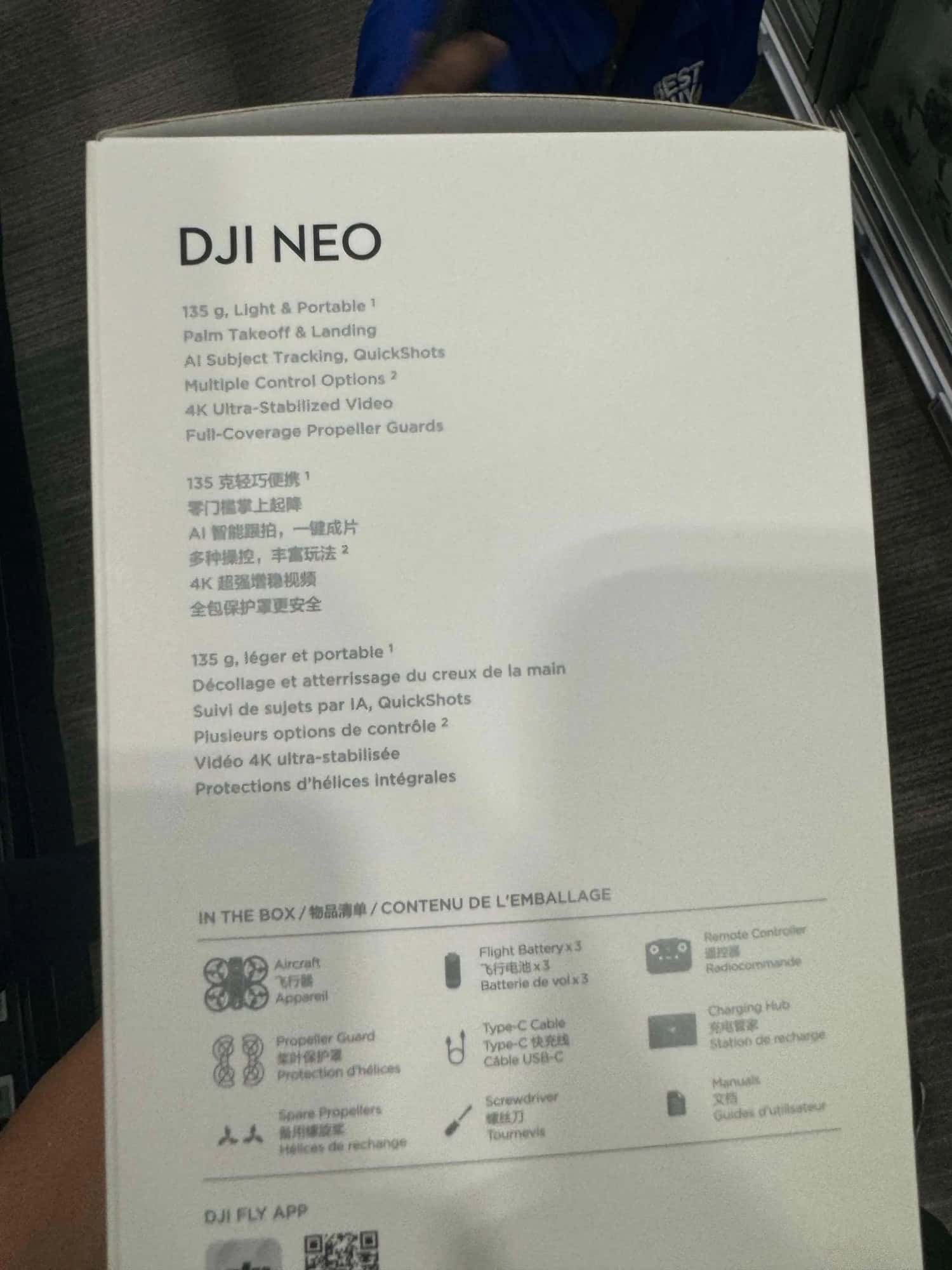DJI Neo retail box on display listing weight, tracking features and box contents.