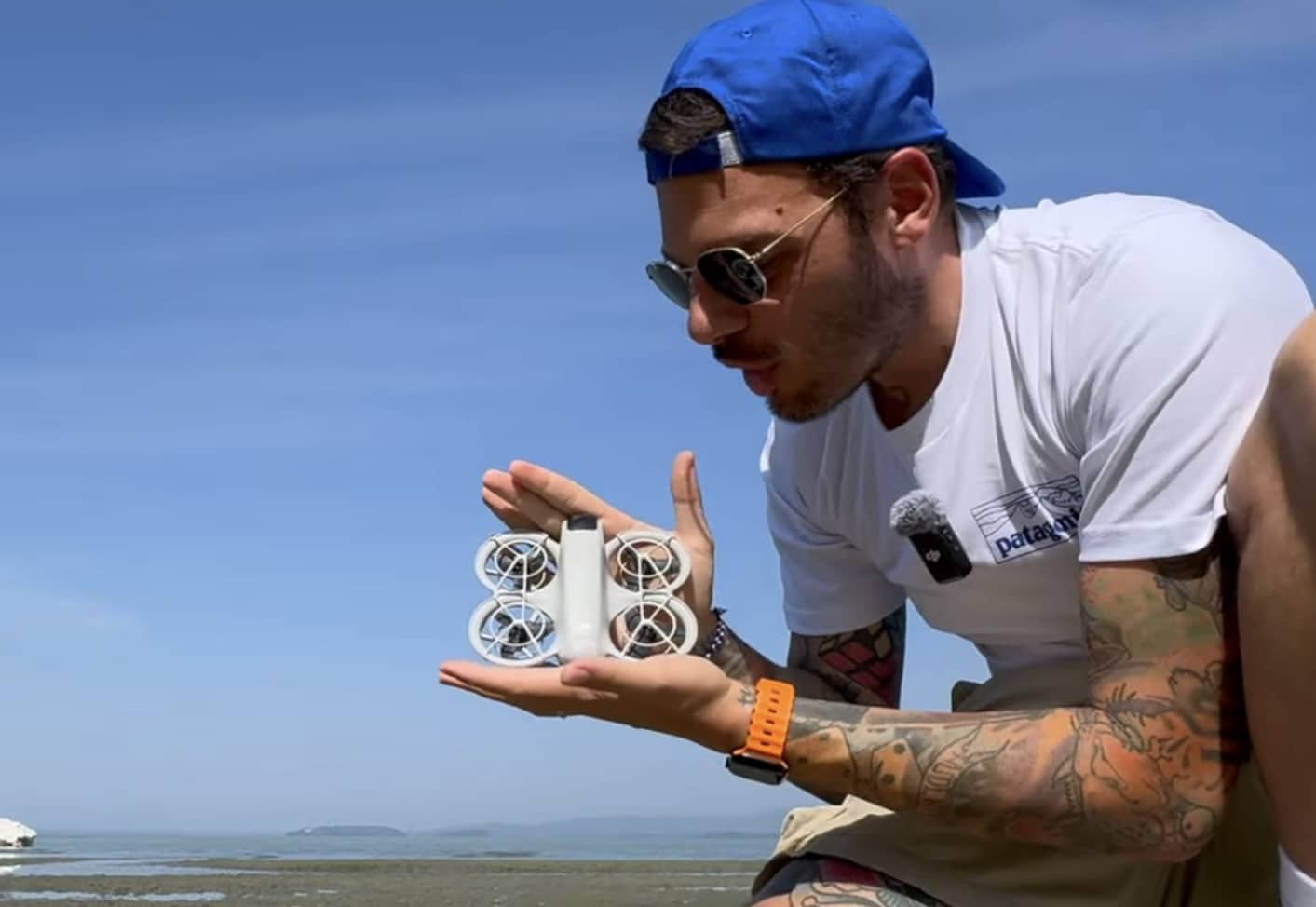 The DJI Neo resting in a palm, showing how small the 135-gram drone is.