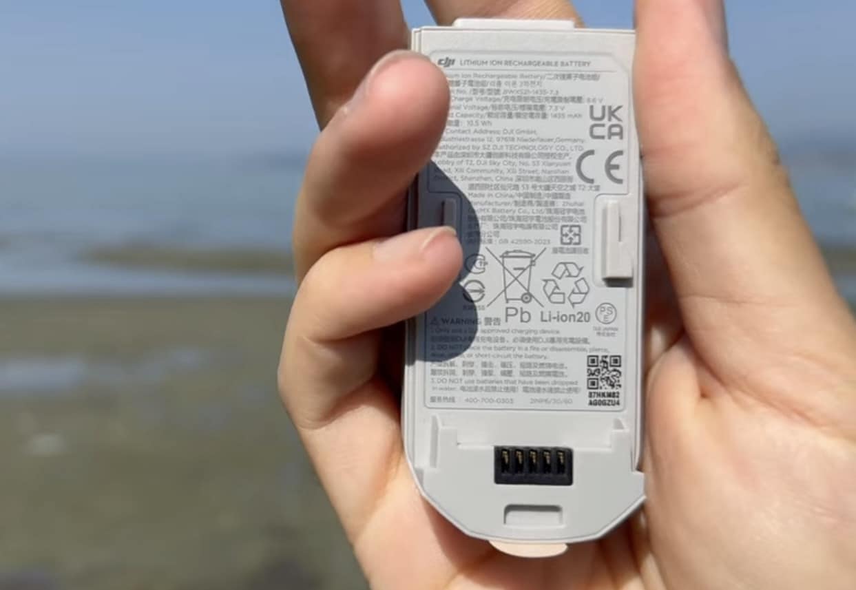 The DJI Neo's flight battery held outside the drone.