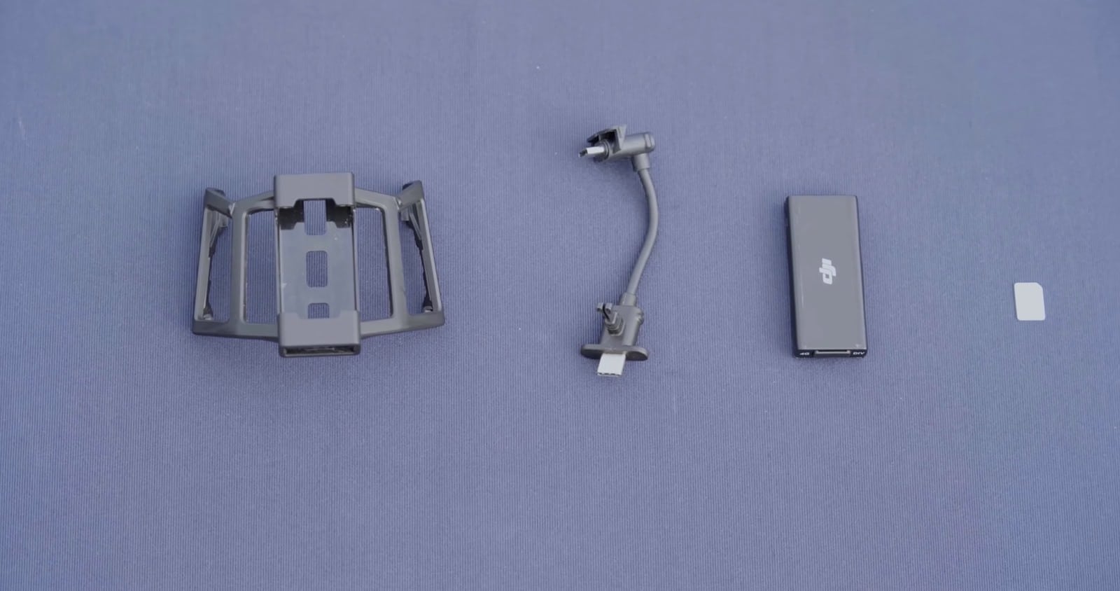 DJI Cellular Dongle kit laid out with mounting bracket, clamp arm and nano-SIM card.