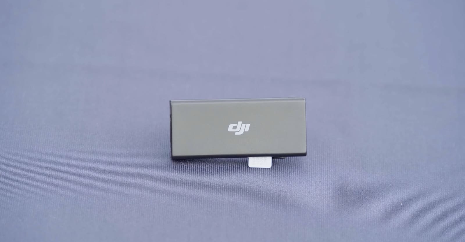 A second cellular dongle resting alone on blue fabric before controller installation.