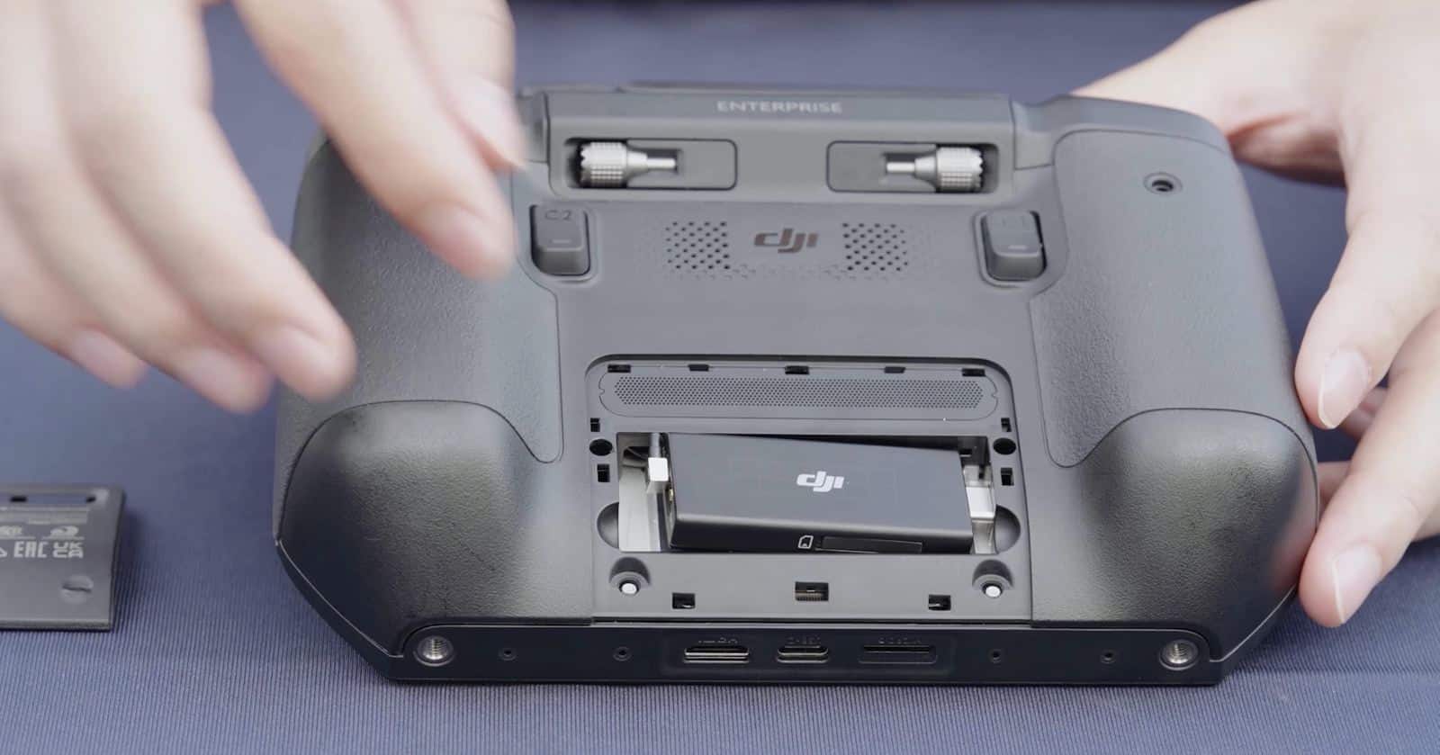 Controller face down with the dongle seated and its cover plate set aside.