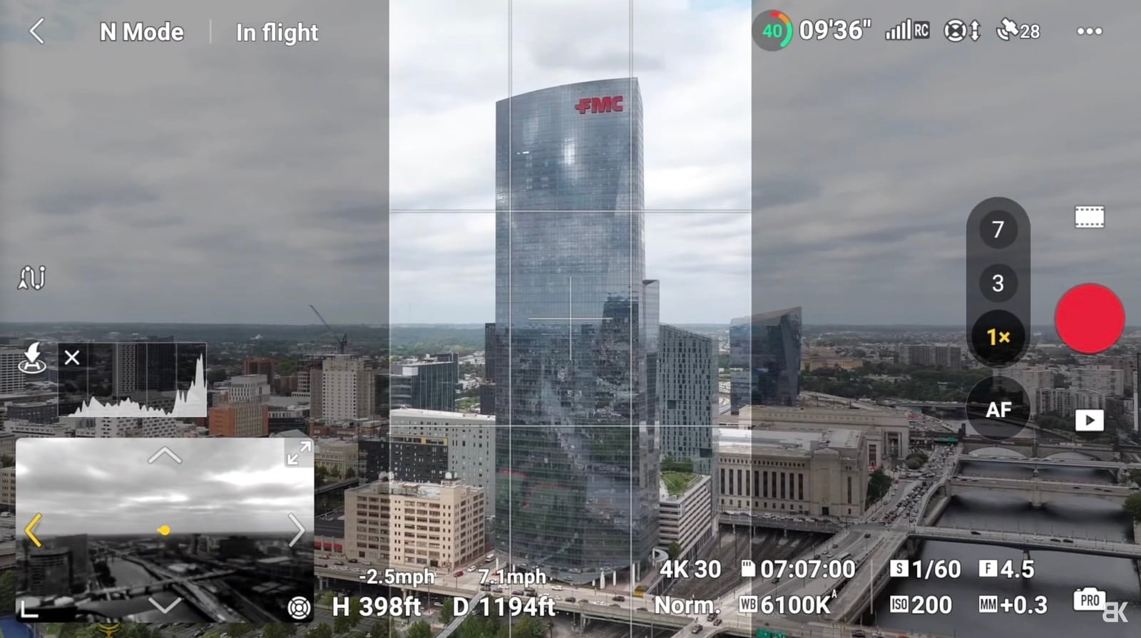 Screenshot of the DJI Fly flight view with grid lines over a city skyline.