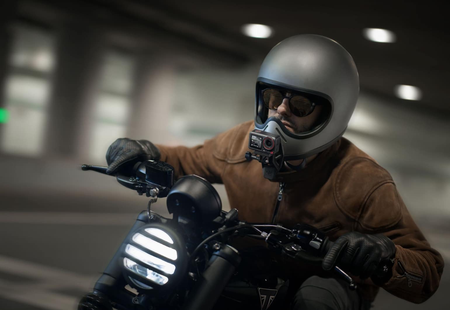 Motorcyclist riding through a parking garage with a camera on his chest mount.