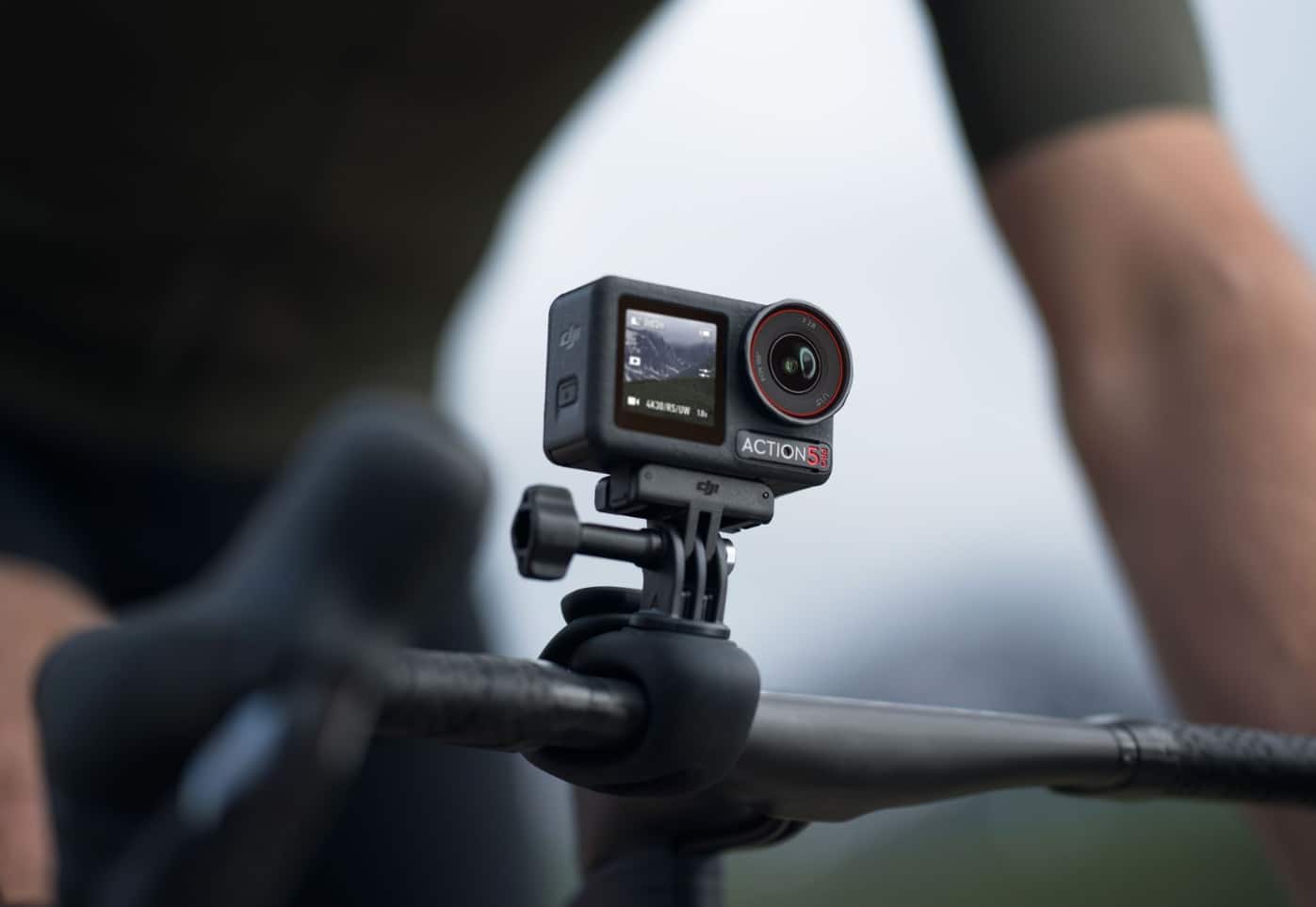 Osmo Action 5 Pro clamped to a bicycle handlebar with its lens facing forward.