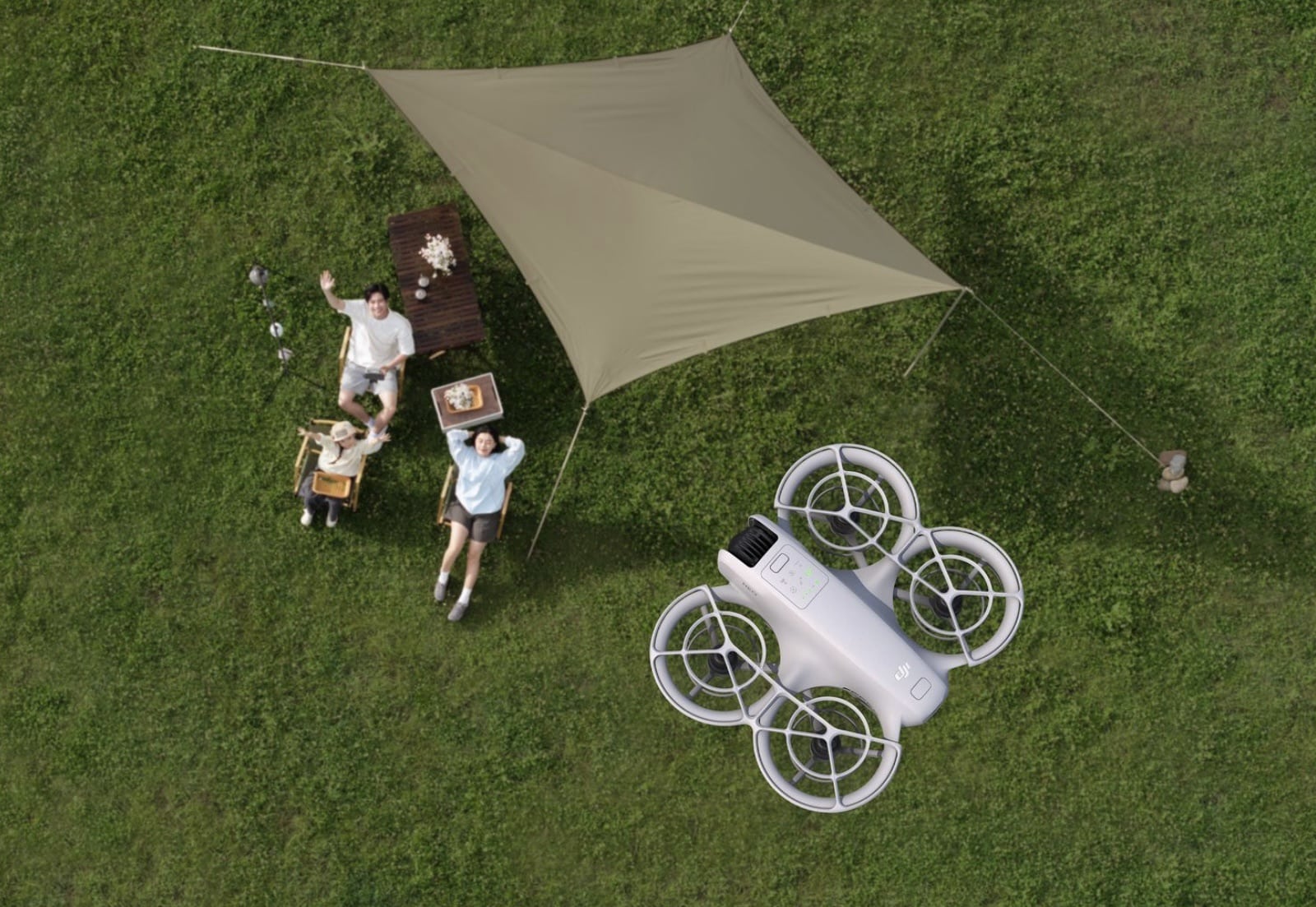 Top-down shot of a picnic under a tarp with the Neo shown alongside.