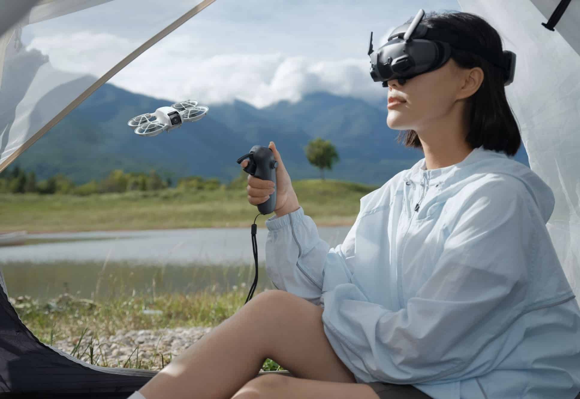Seated in a tent, a pilot wearing DJI Goggles flies the Neo by motion controller.