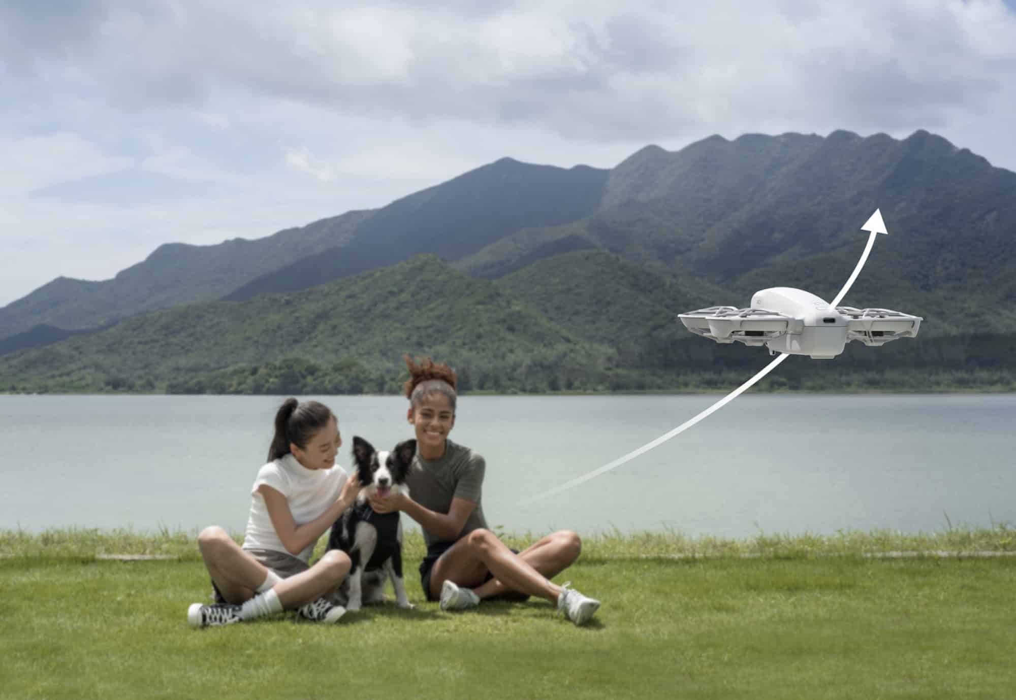 A white arrow shows the Neo climbing away from two people and a dog.