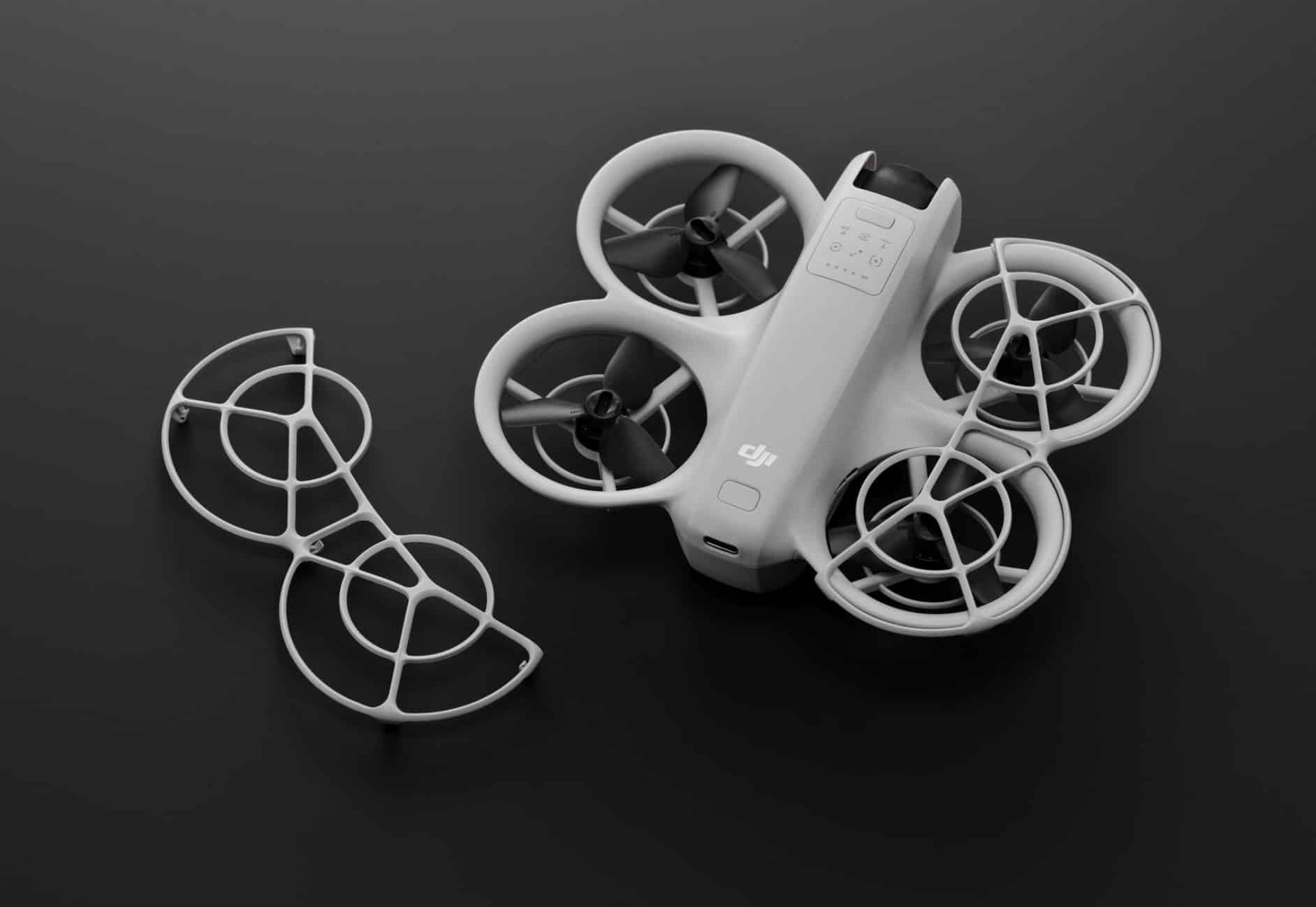 The Neo on a dark surface with a removable propeller guard set beside it.