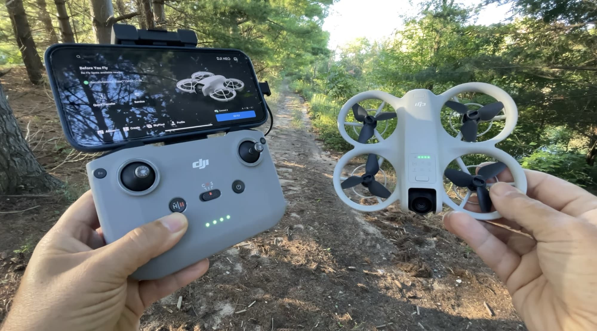 DJI RC-N3 controller with a phone running DJI Fly beside the Neo.