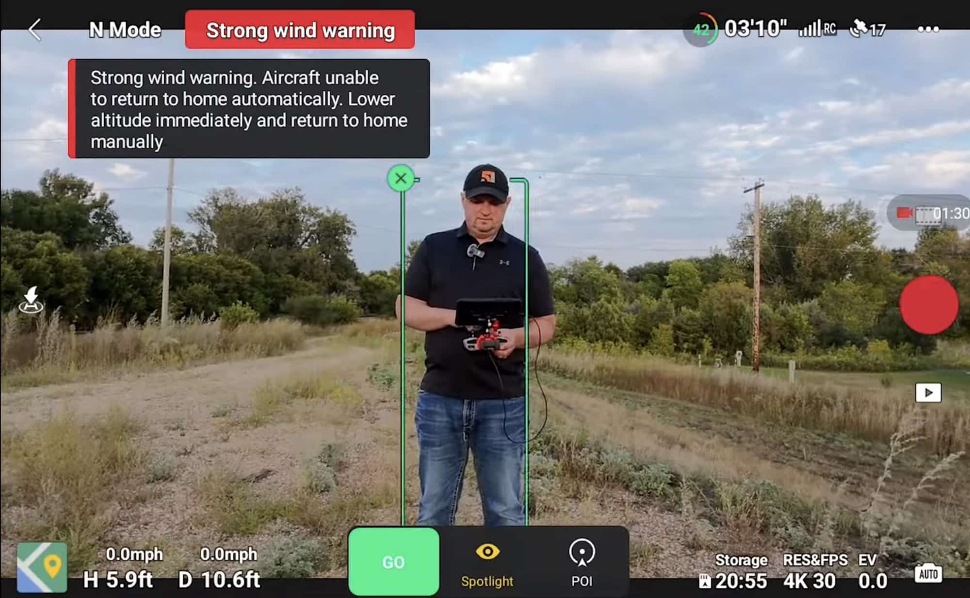 Screenshot of ActiveTrack framing a pilot holding a controller during a wind warning.