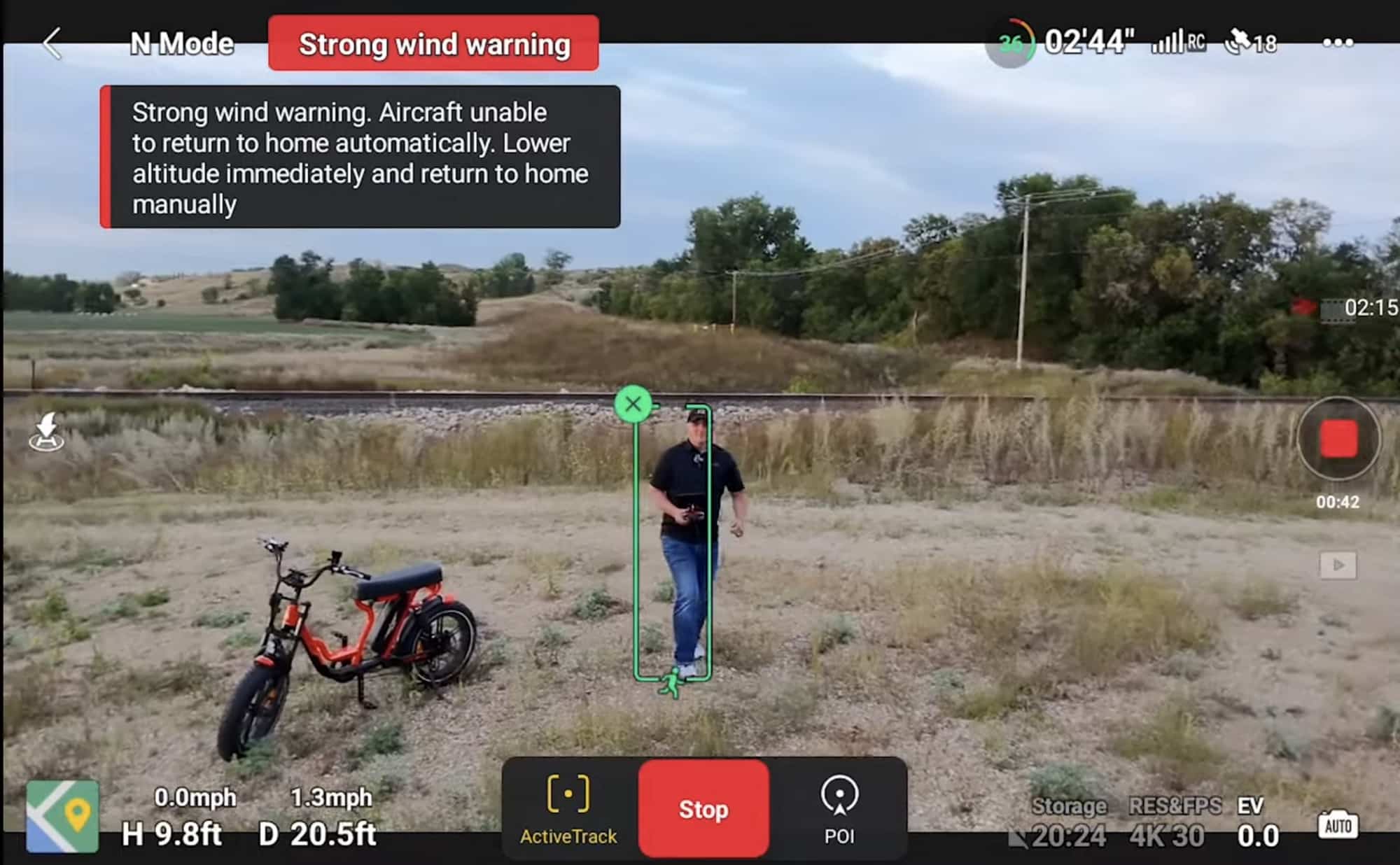 Screenshot of a strong wind warning while the Neo tracks a man near an e-bike.