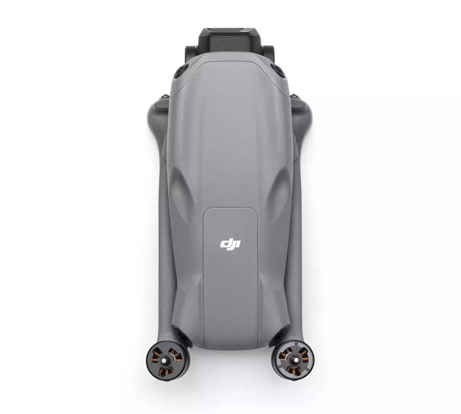 Folded drone photographed straight down, arms tucked along the body over the motors.