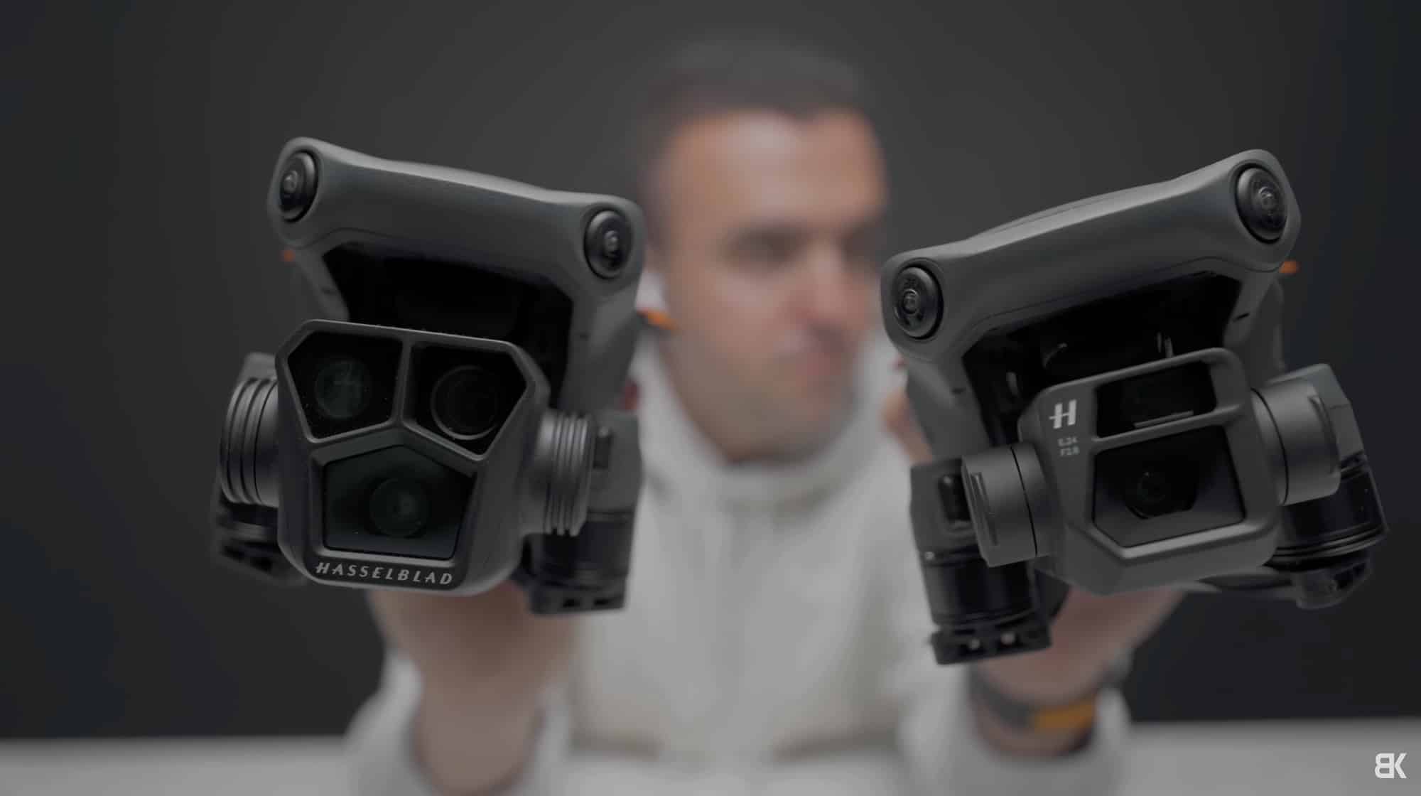 Billy Kyle holding two DJI drones with their Hasselblad gimbals facing the camera.