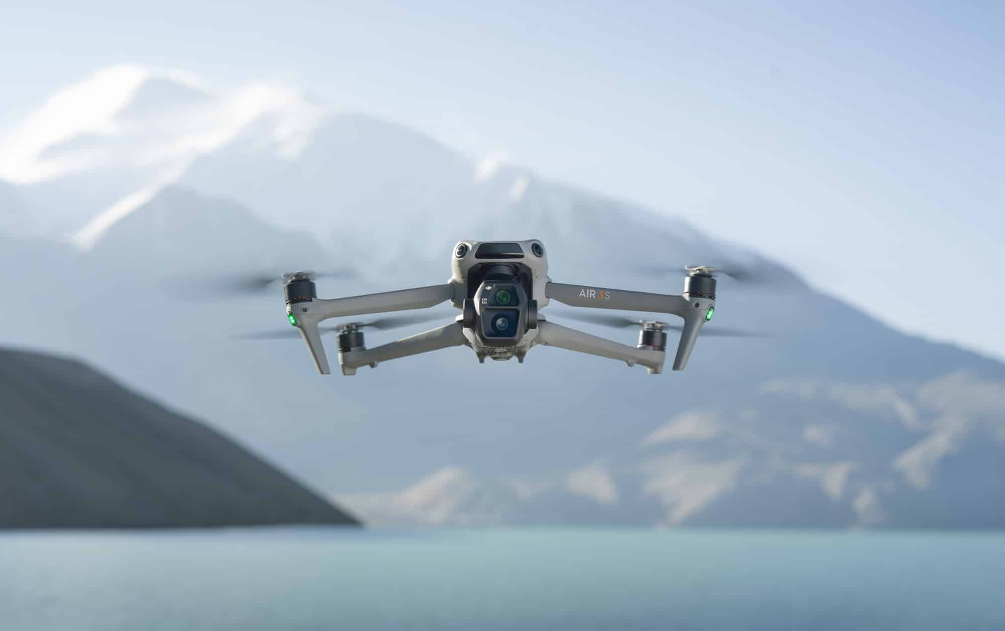 Air 3S approaches the camera with a hazy snow-capped peak behind it.