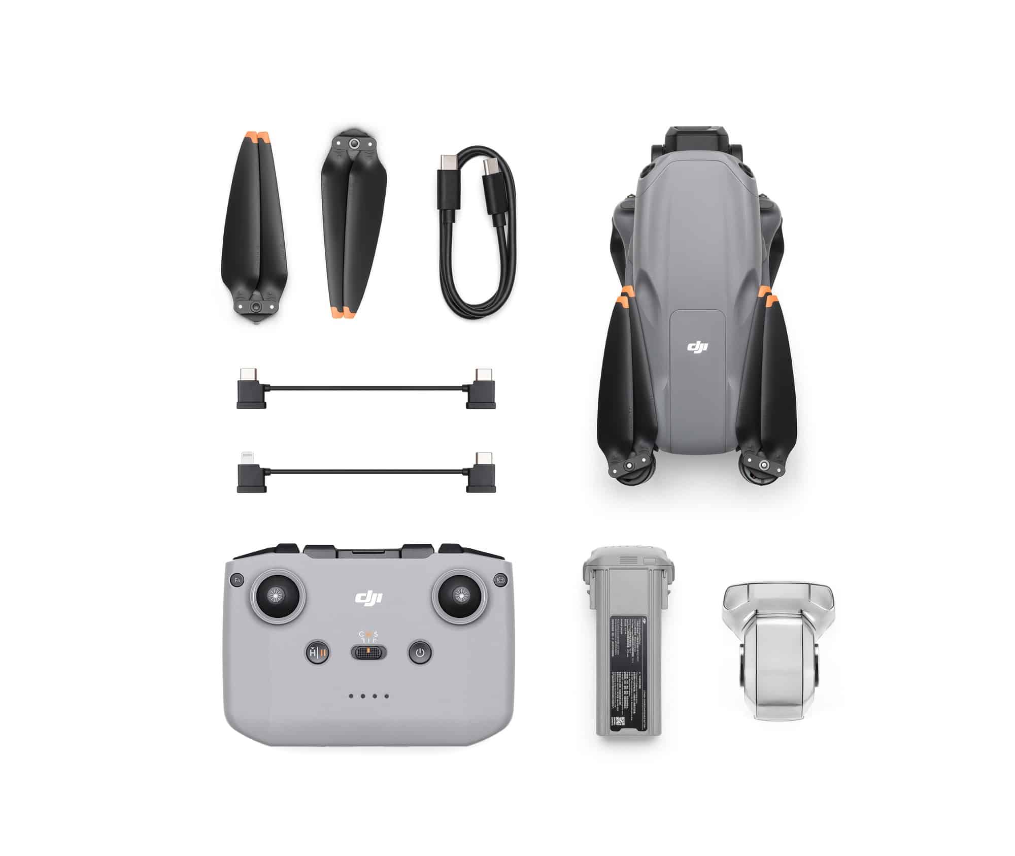 DJI Air 3S kit contents laid out with propellers, controller and a charging hub.