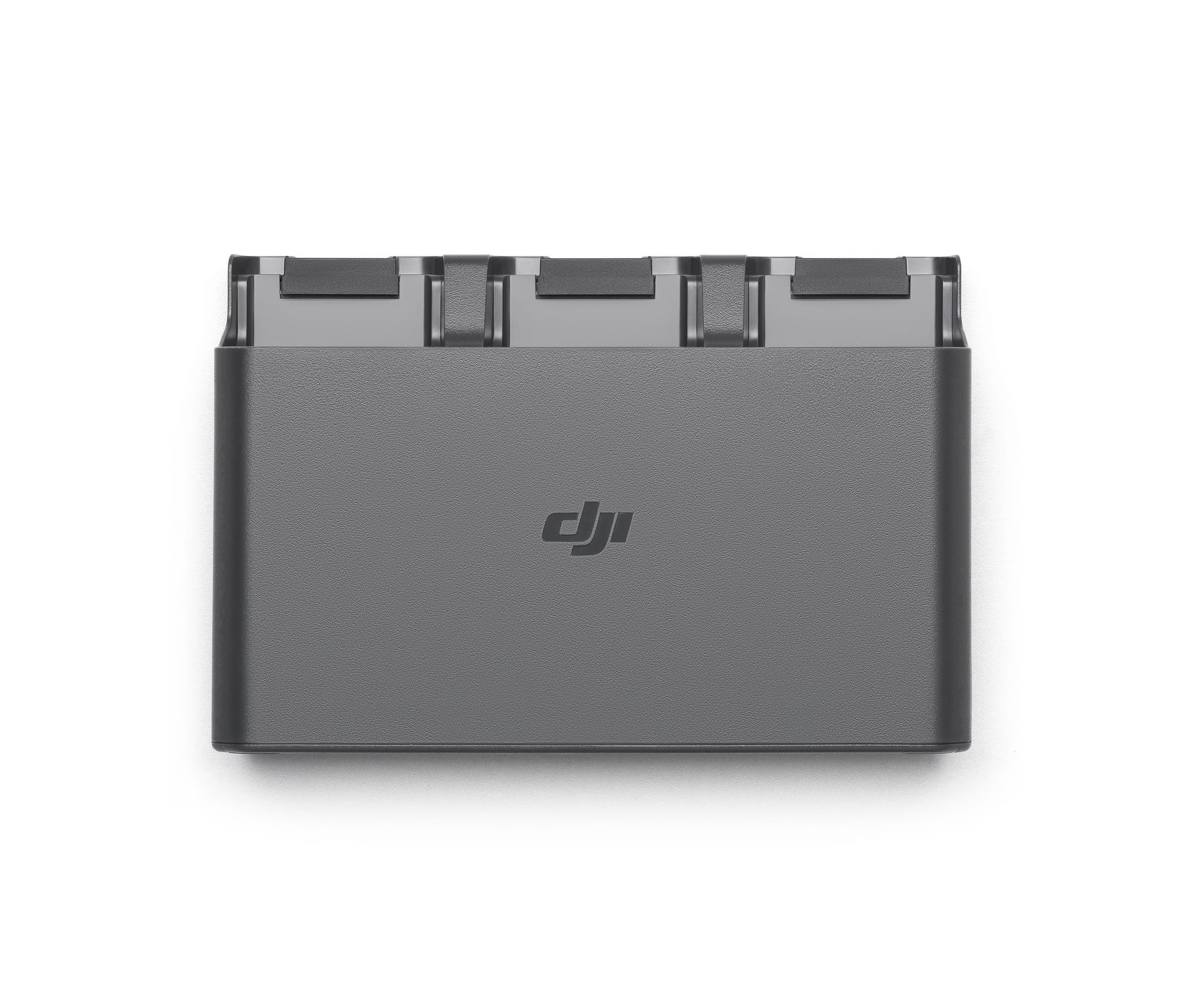 Three-bay charging hub loaded with batteries, DJI logo on the front face.