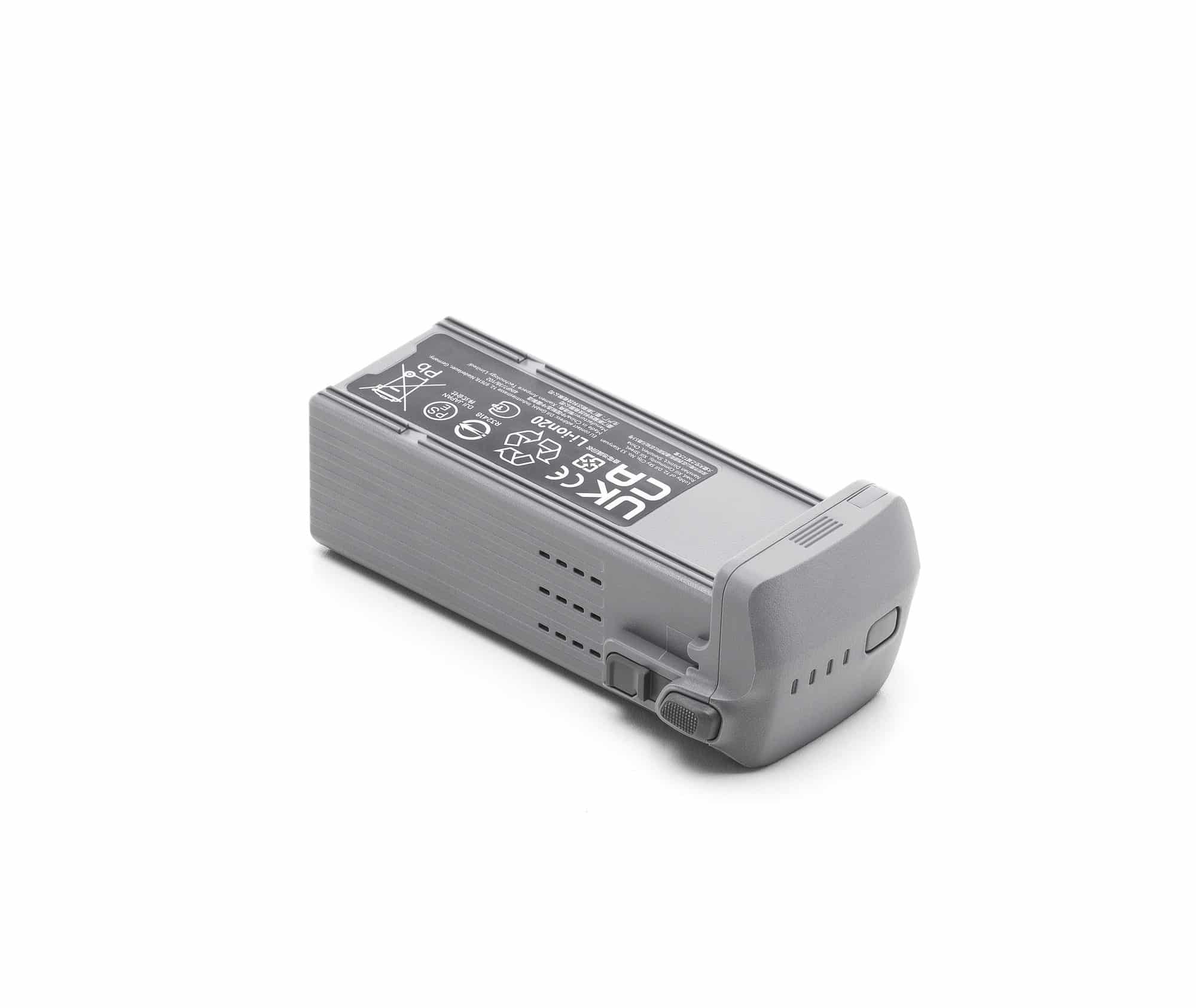 Flight battery tilted to reveal its release button and ventilation slots.