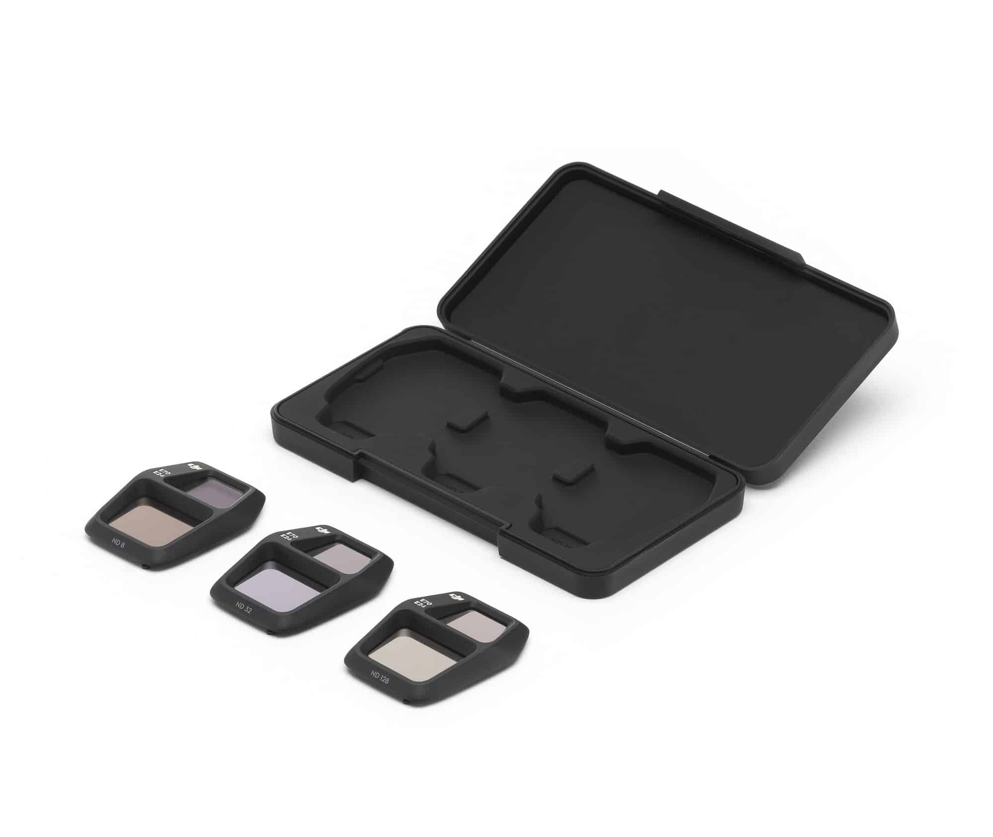 Empty filter case open beside three ND filters laid out on white.