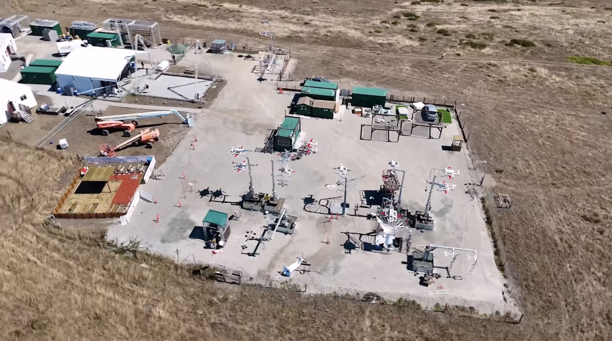 Aerial view of a Zipline outdoor test pad with aircraft and support tents.