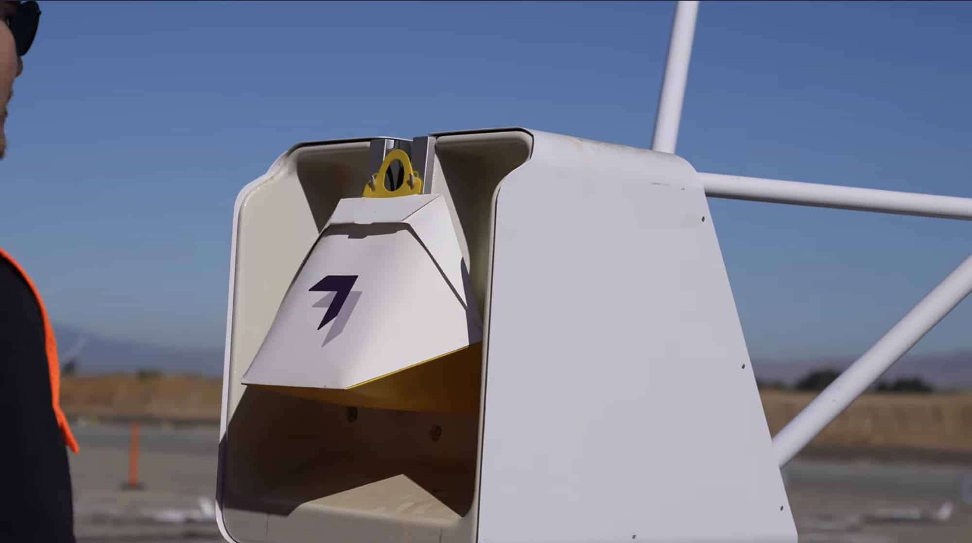 Package attachment mechanism on a Wing delivery drone captured in slow motion.