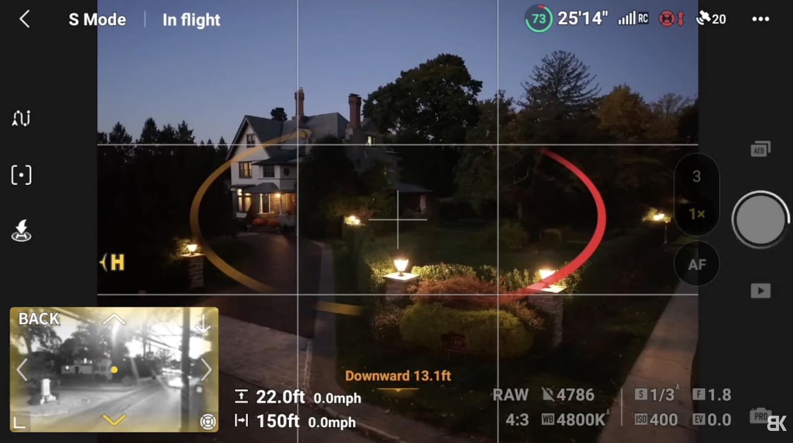 Screenshot of the DJI Fly flight screen showing obstacle avoidance arcs over a house at dusk.