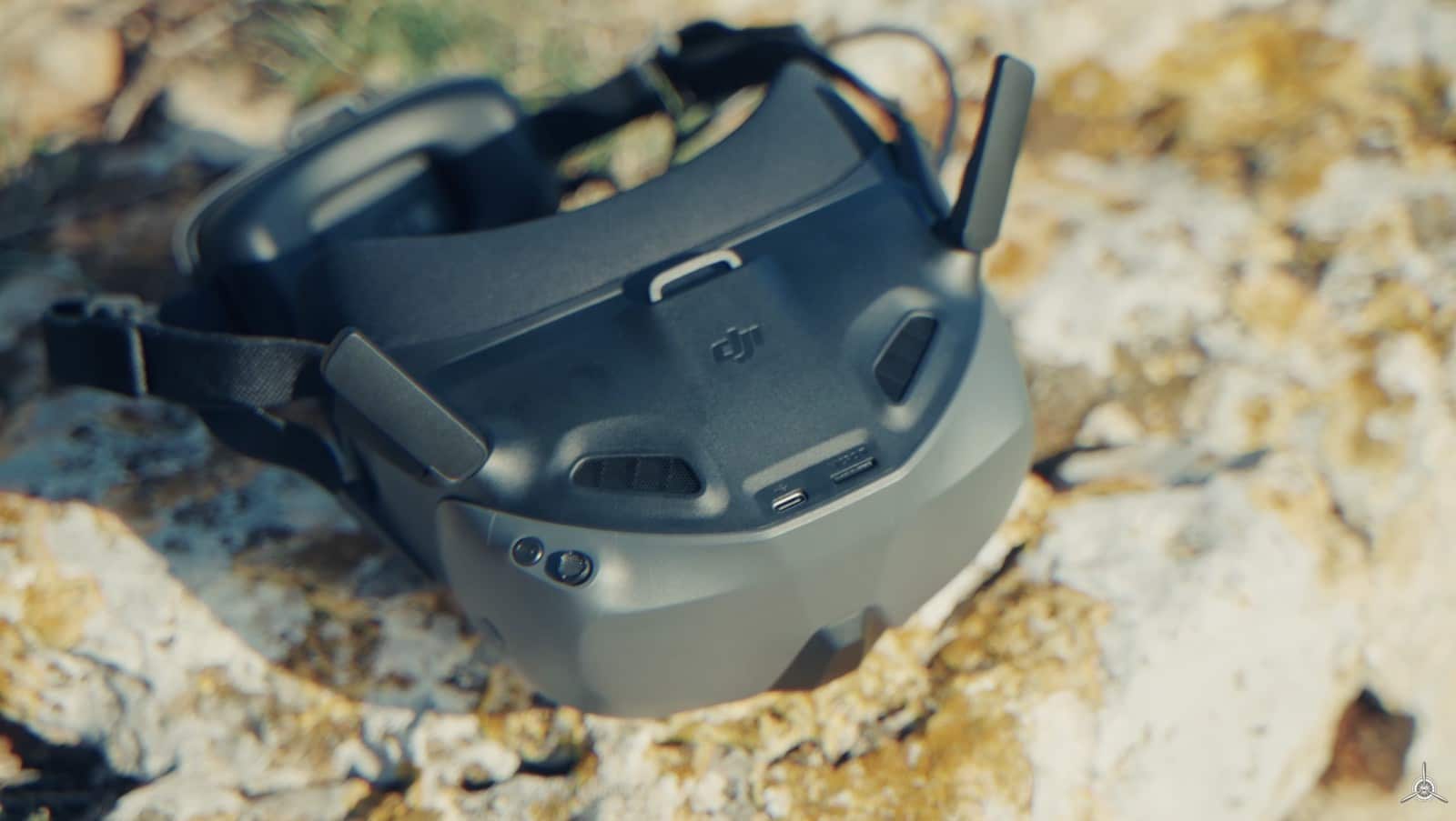Goggles N3 resting on a lichen-covered rock with the head strap laid out.