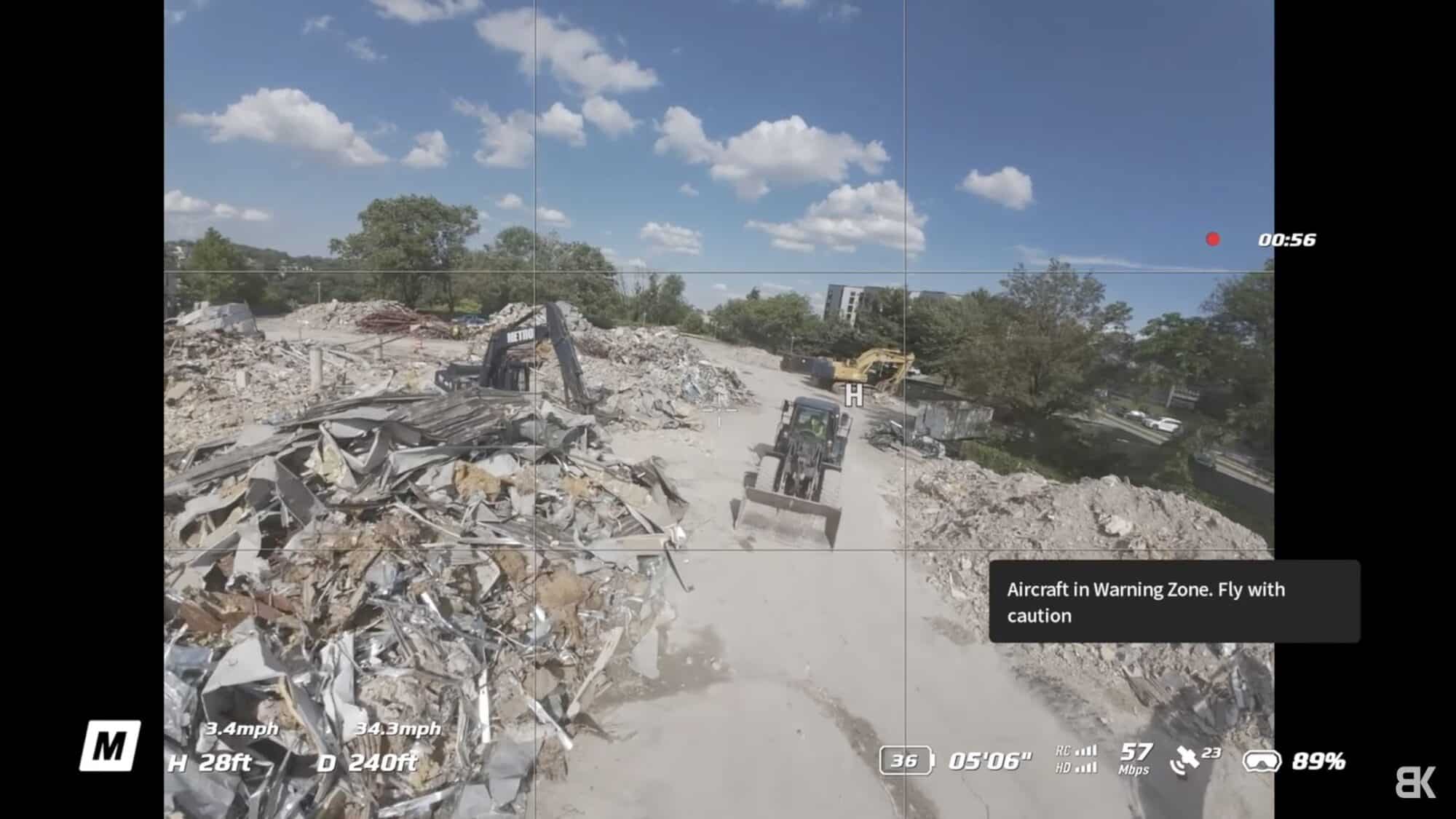 Goggles view over a demolition site with a warning zone prompt at 28 feet.