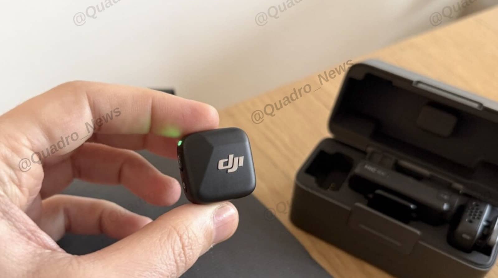 The receiver labeled MIC RX sitting beside two DJI Mic Mini transmitters.