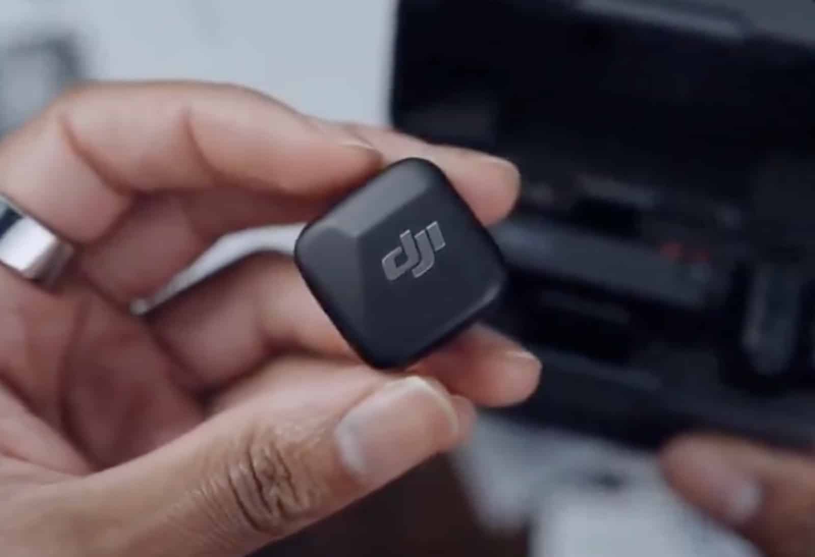 Close view of a 10-gram Mic Mini transmitter and its LED status indicator.