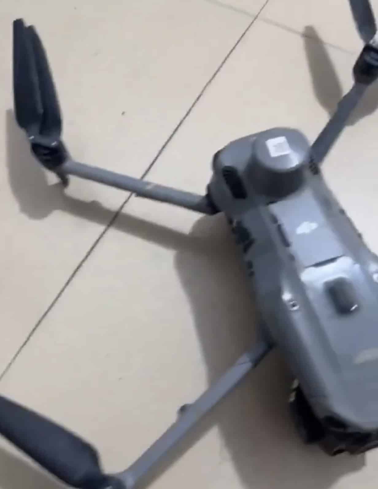 The unbranded Mavic-style prototype lies unfolded on a tiled floor.