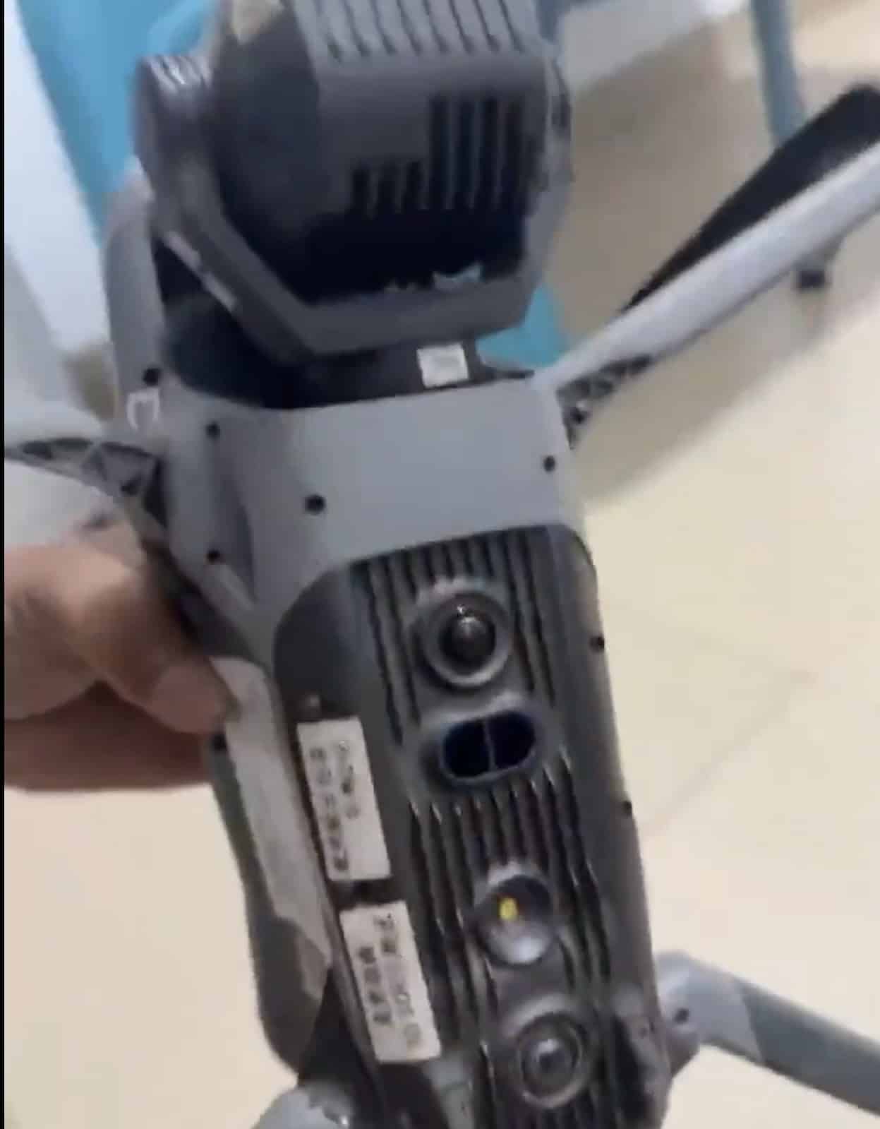 The prototype's underside showing a vision sensor array and Chinese factory labels.