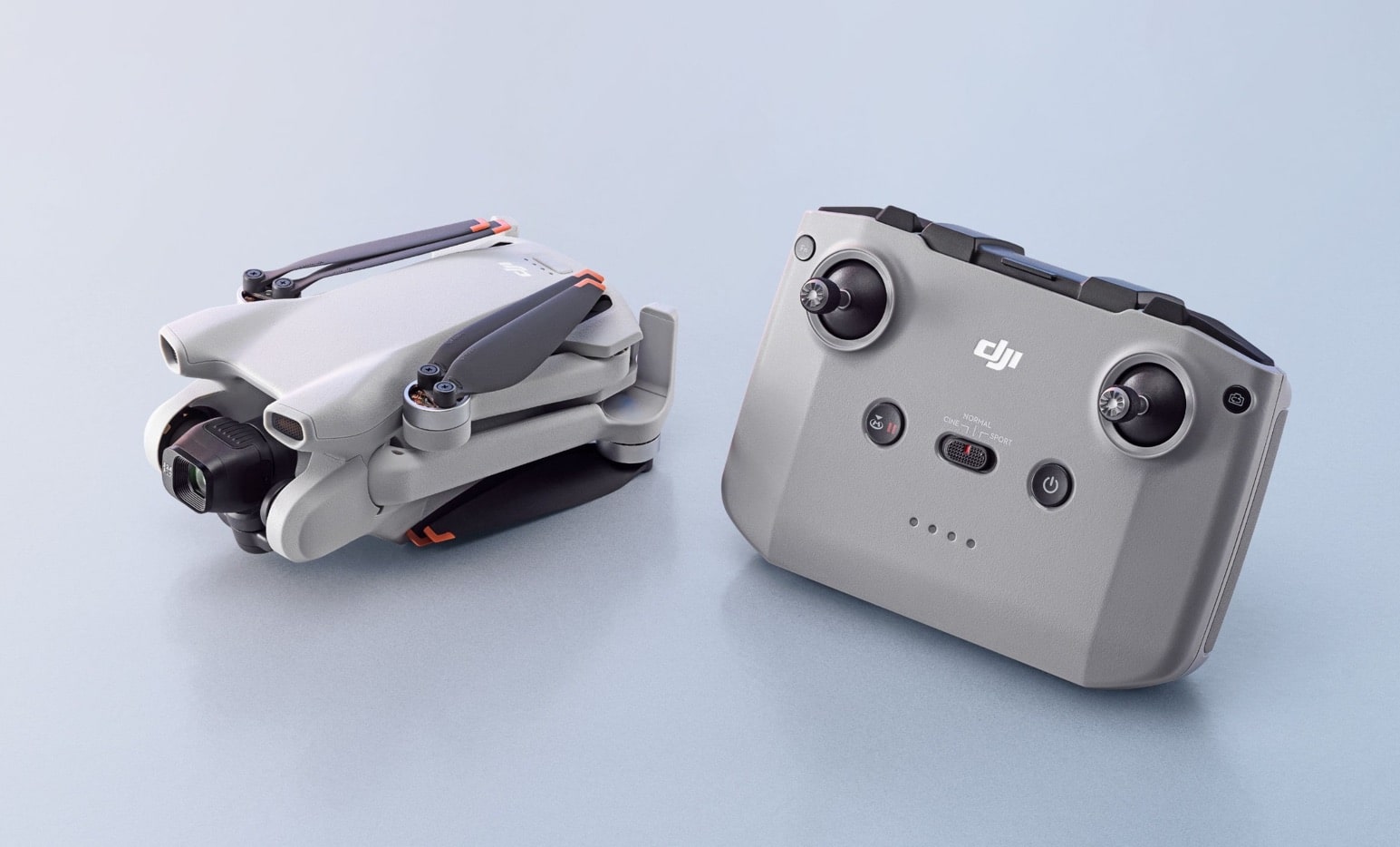 Folded DJI Mini 3 shown beside its grey RC-N1 remote controller.