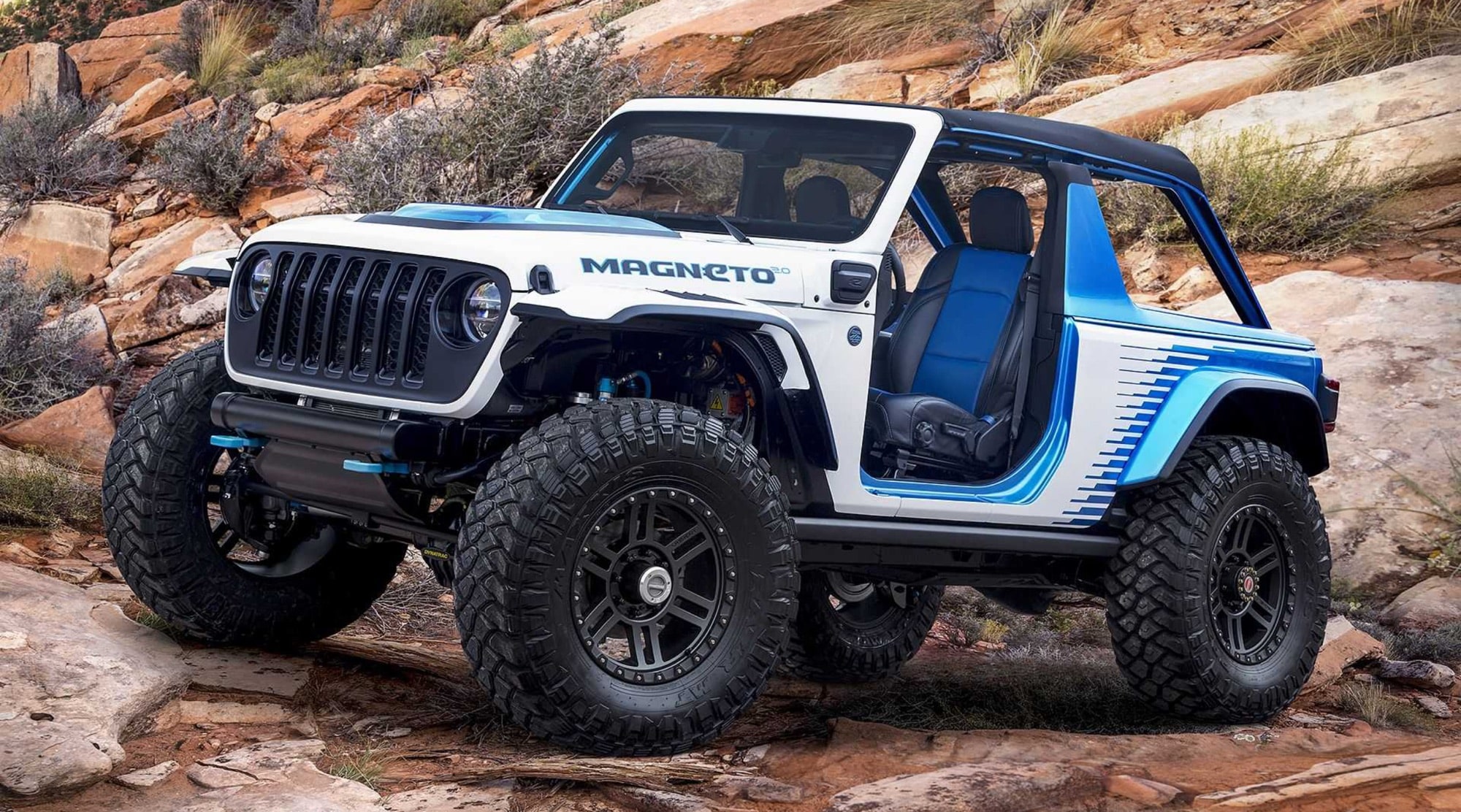 White and blue Jeep Wrangler Magneto concept parked on red desert rock.